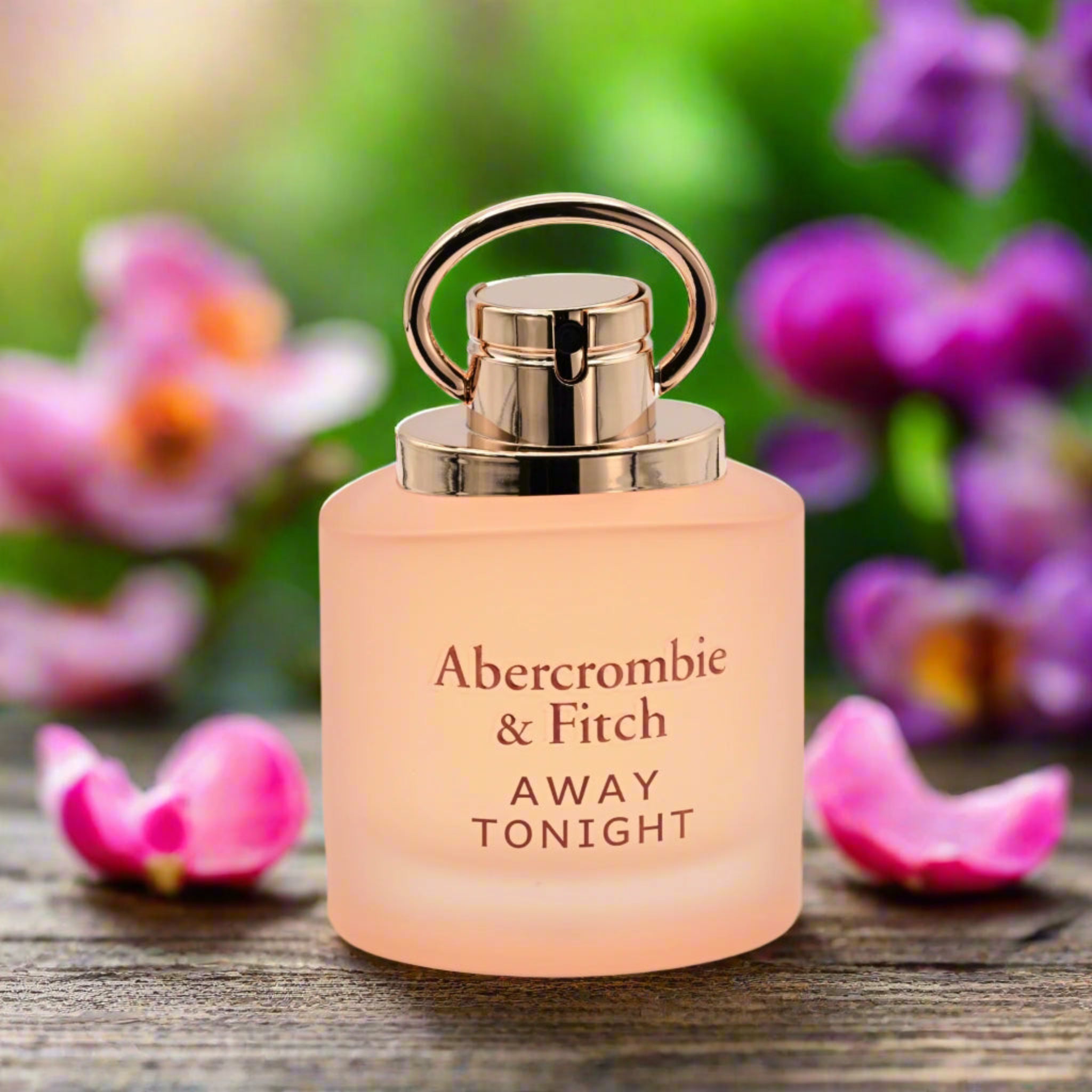 Perfume bottle of Abercrombie & Fitch 'Away Tonight' with flowers in the background