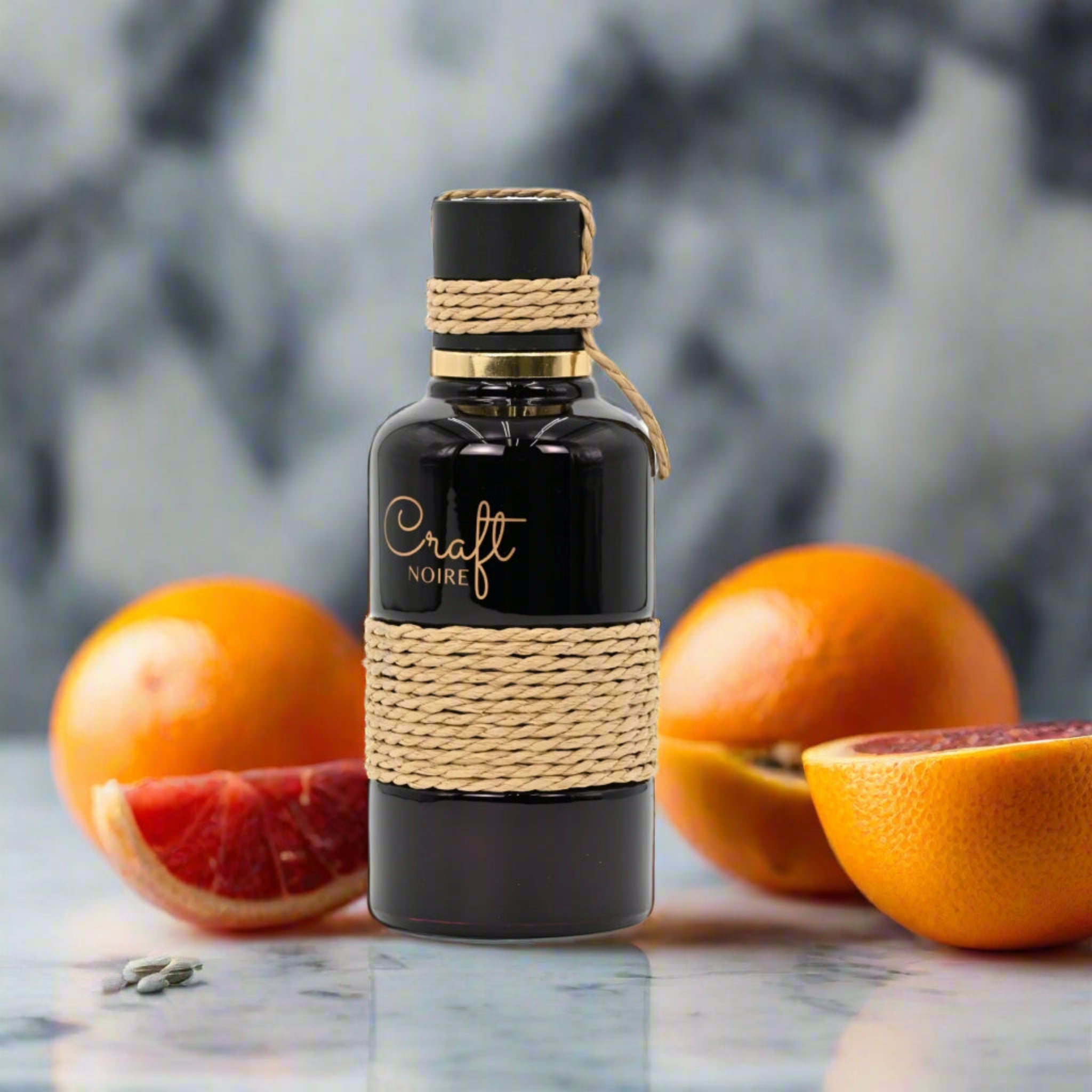 Bottle of 'Craft Noire' with grapefruits on a marble surface
