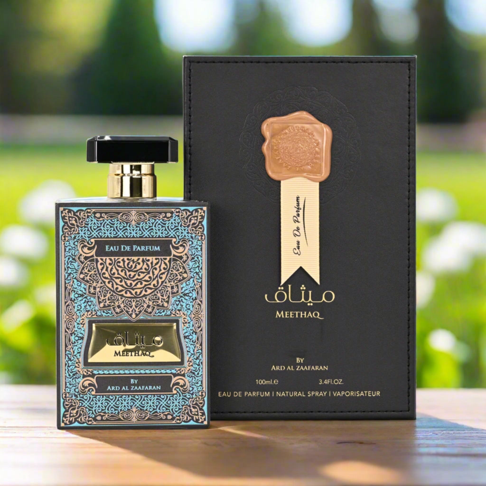 Eau de Parfum bottle and packaging with 'Meethaq' branding on a blurred natural background