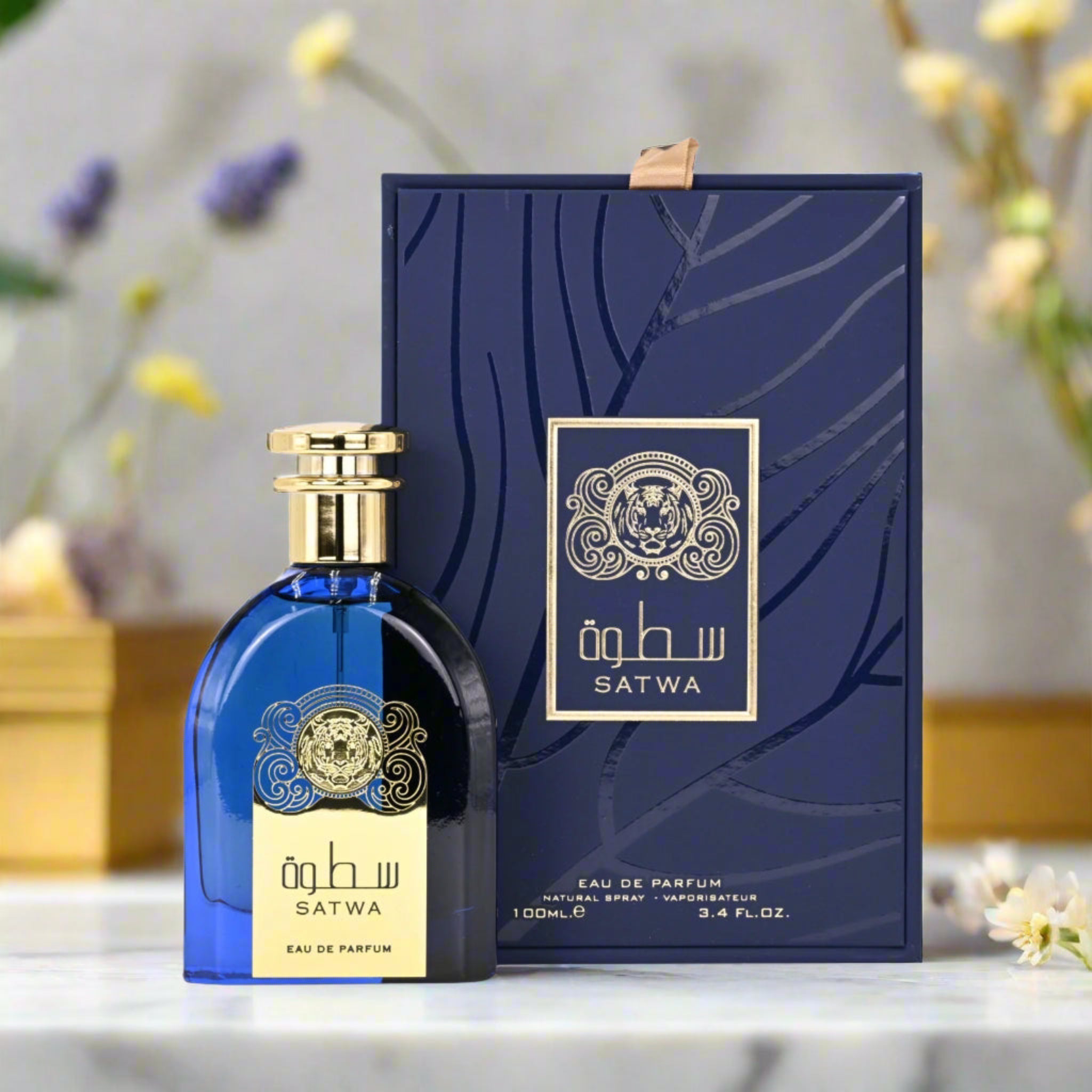 Blue Satwa perfume bottle and packaging on a decorative background