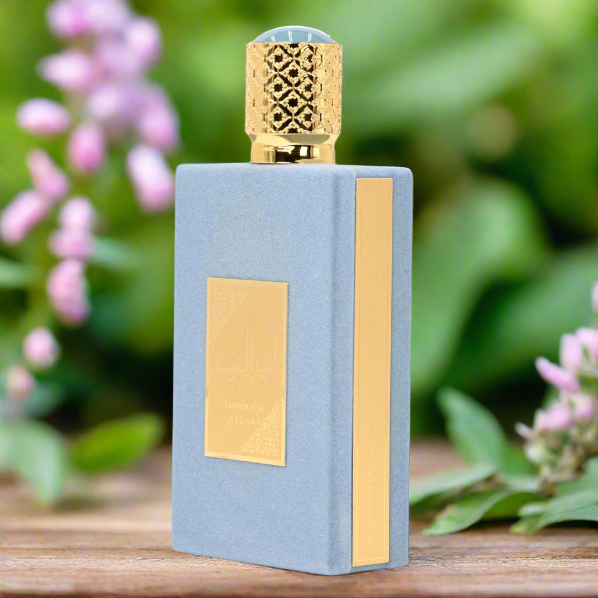 Perfume bottle with gold accents on a wooden surface with a blurred natural background