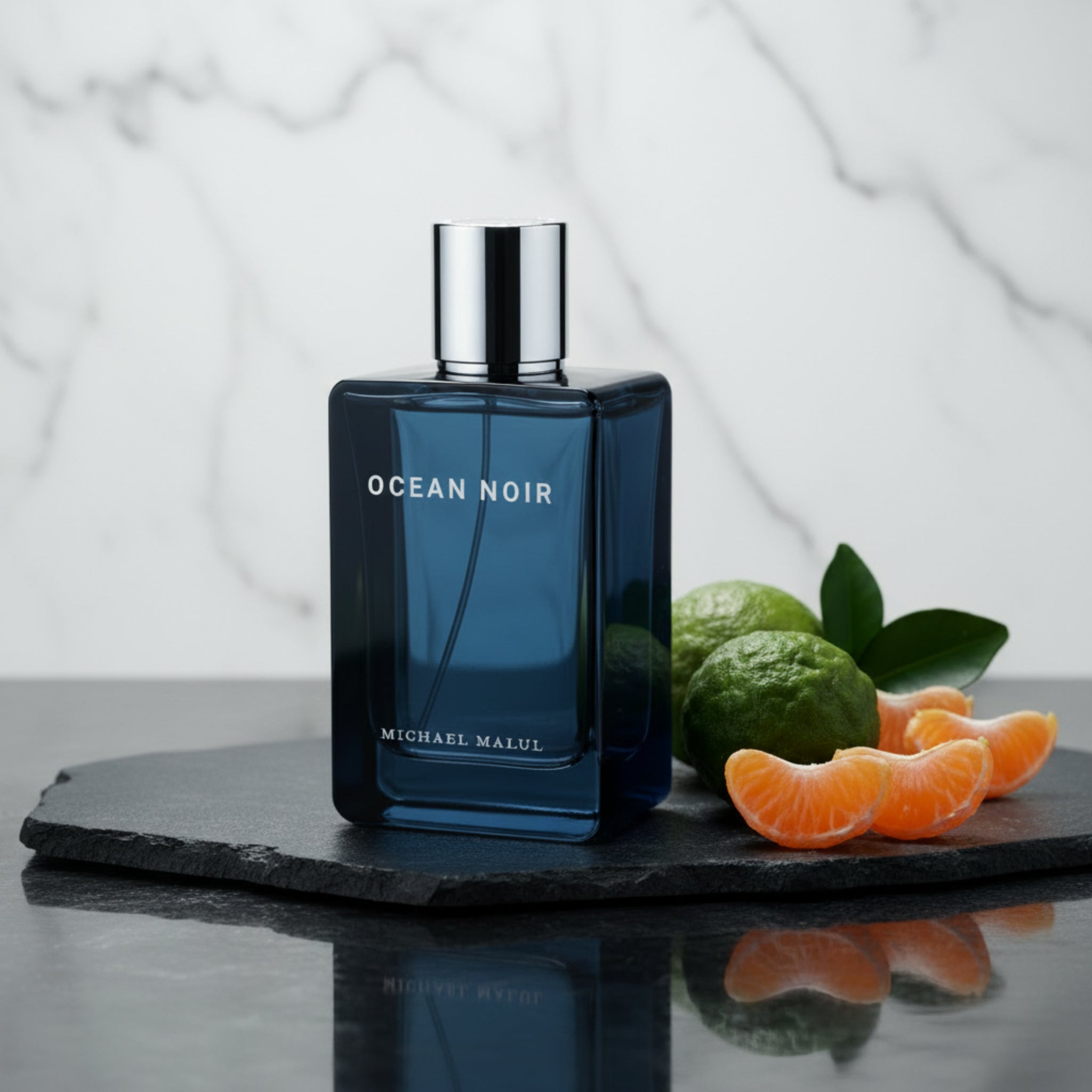 Blue perfume bottle labeled 'Ocean Noir' by Michael Malul on a white background