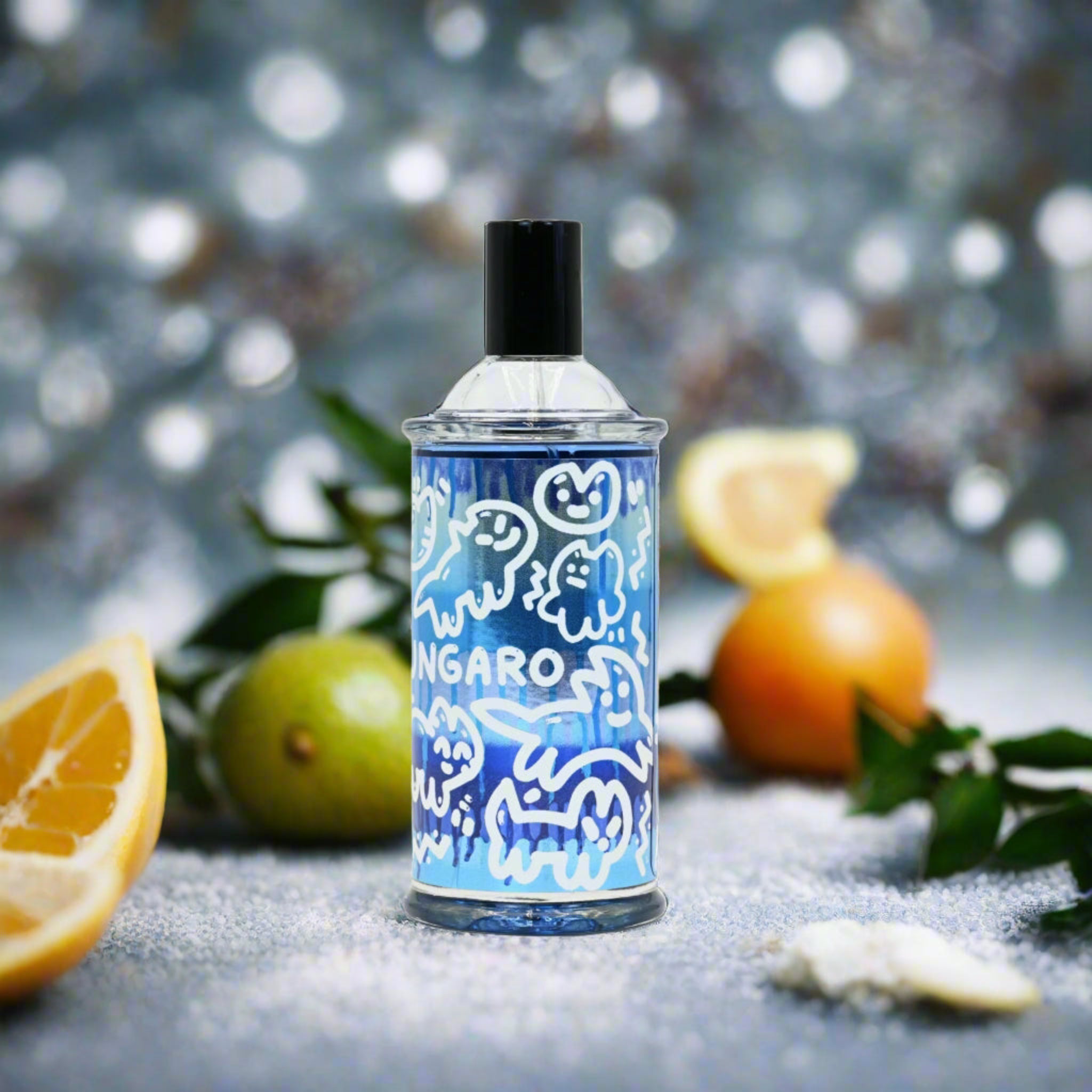 Blue and white patterned bottle with oranges and leaves on a textured surface