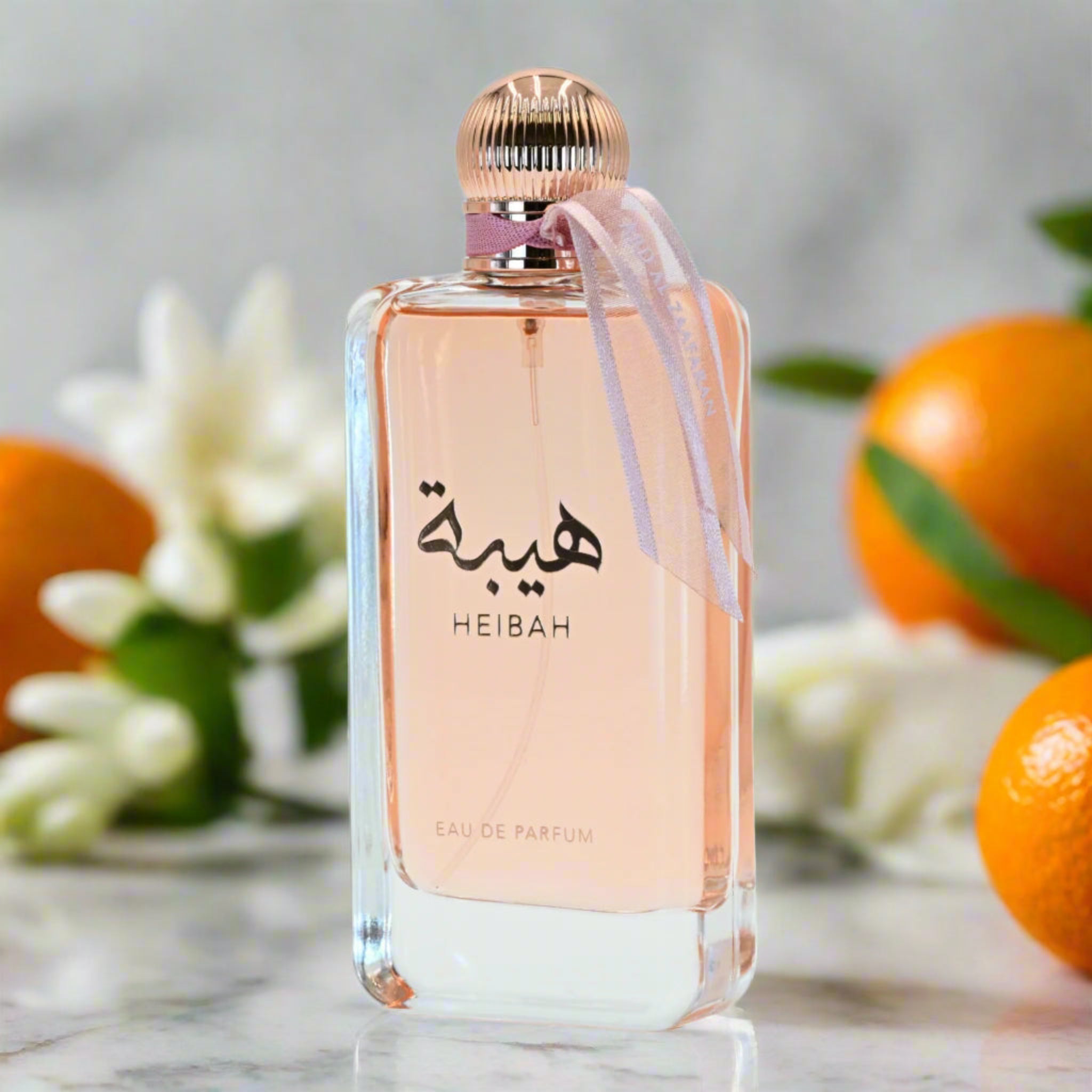 Perfume bottle labeled 'HEIBAH' with oranges and flowers in the background