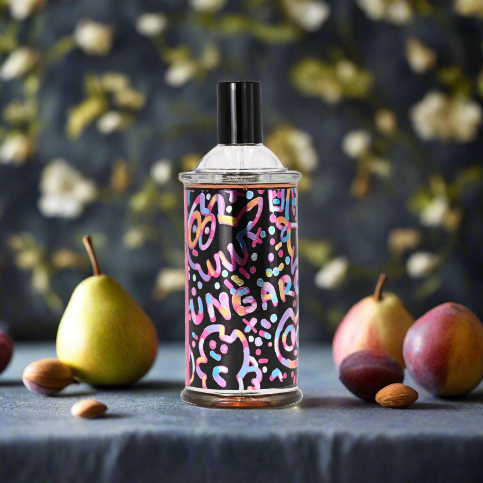 Colorful spray can with abstract design on a dark surface with fruits and flowers in the background