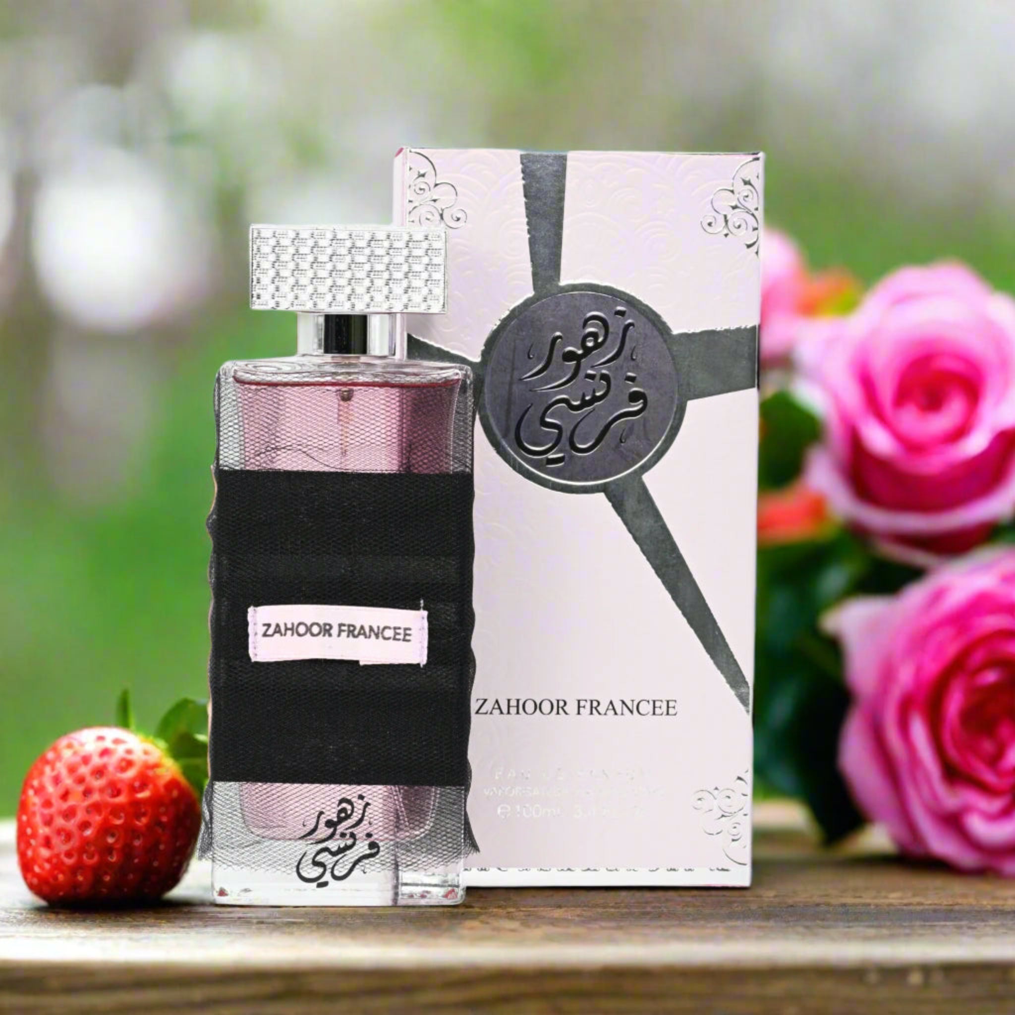 Zahoor Francee perfume bottle and packaging with pink roses and a strawberry in the background