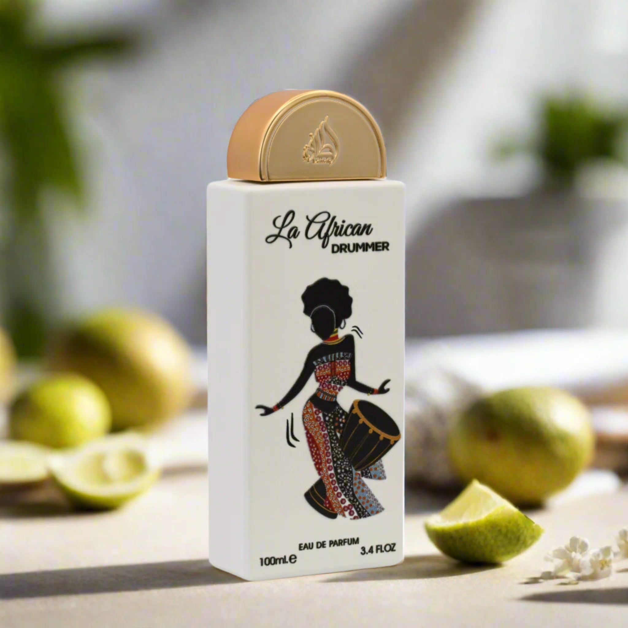Perfume bottle labeled 'La African Drummer' with a silhouette design on a blurred natural background.