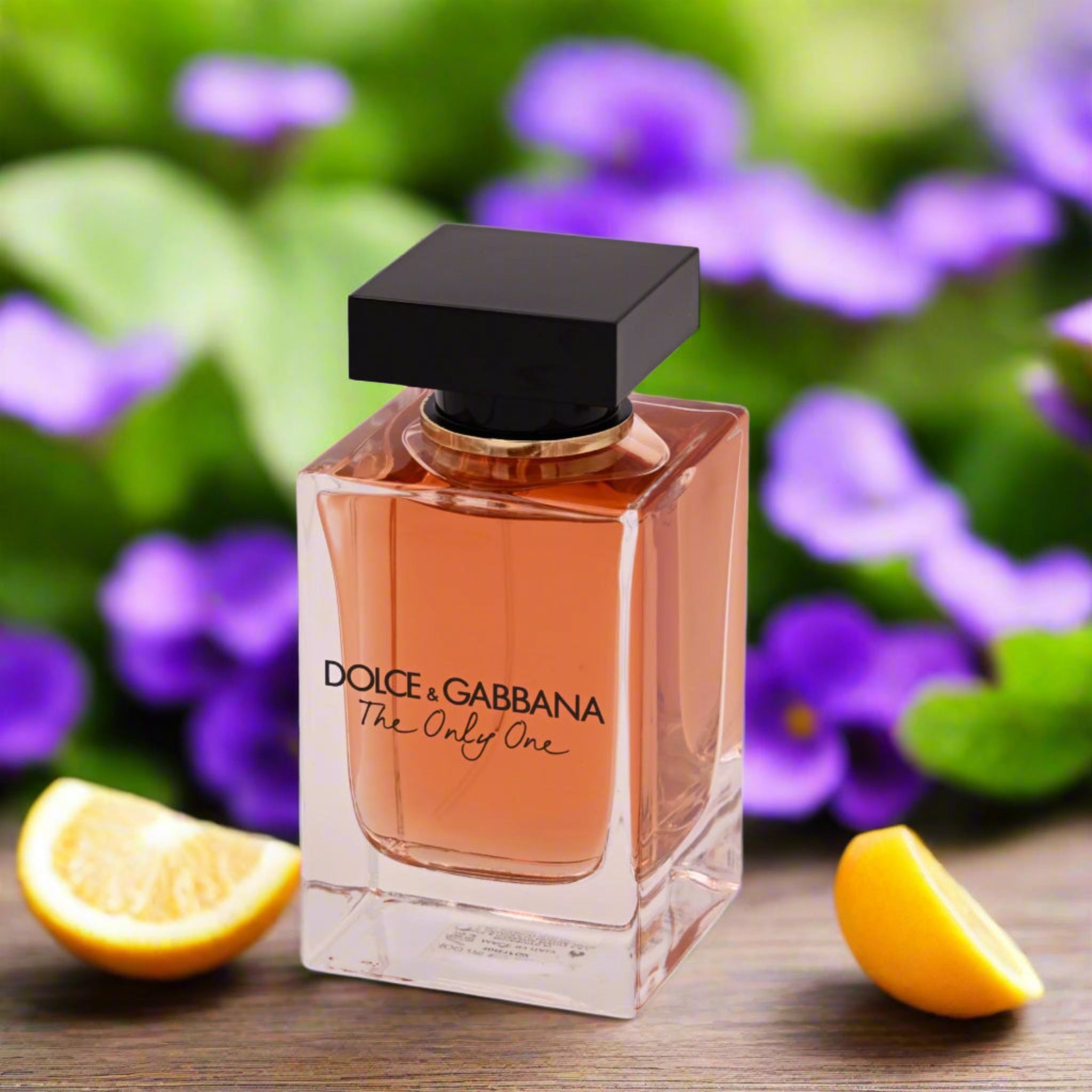 Dolce & Gabbana perfume bottle with lemon slices on a floral background