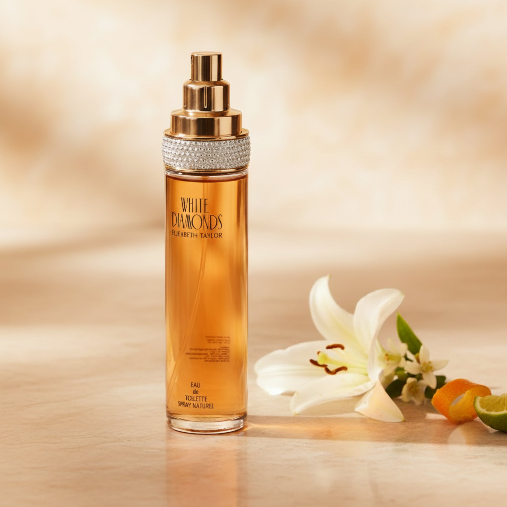 Orange perfume bottle with gold and silver cap on a white background