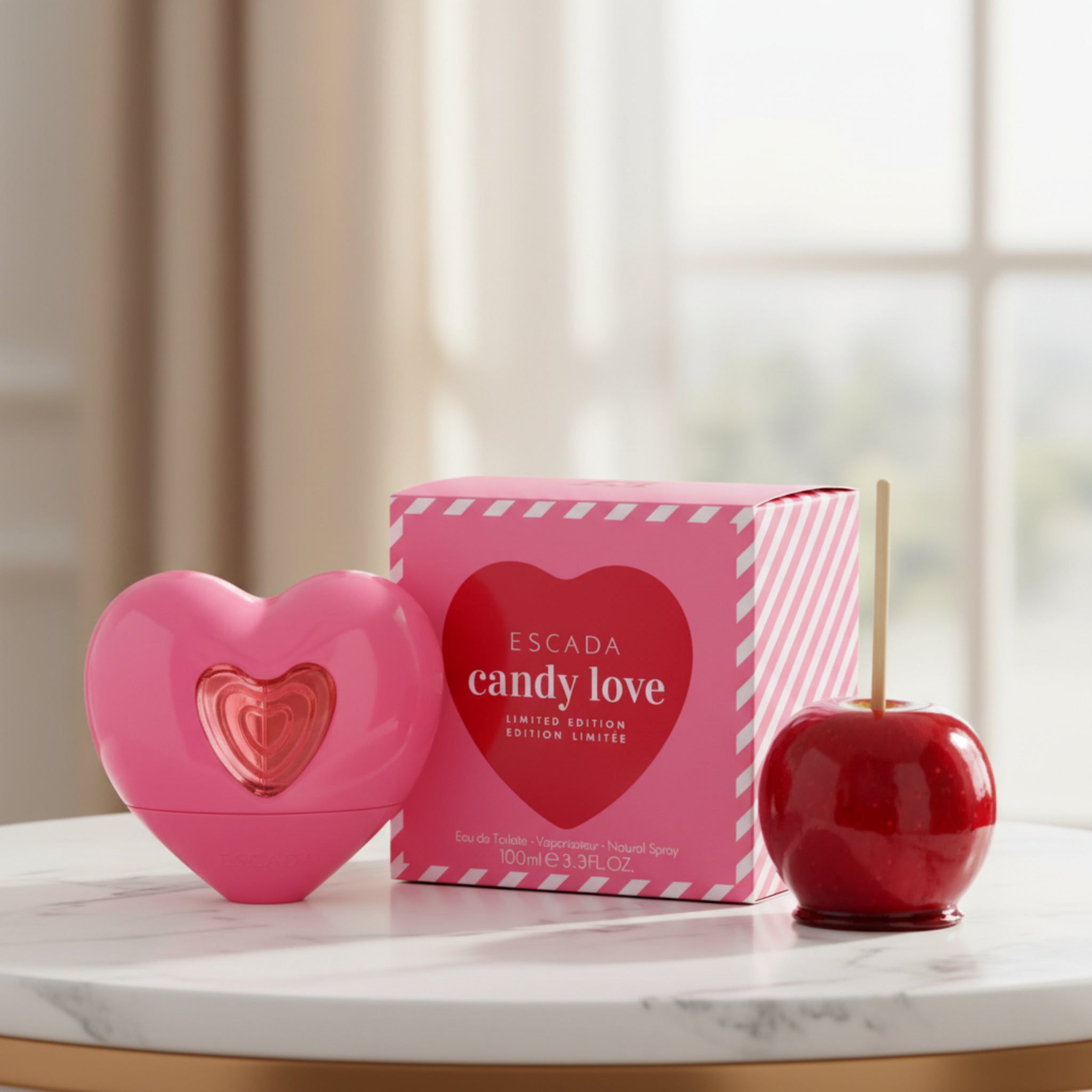 Pink heart-shaped Escada candy love perfume bottle and packaging on a white background