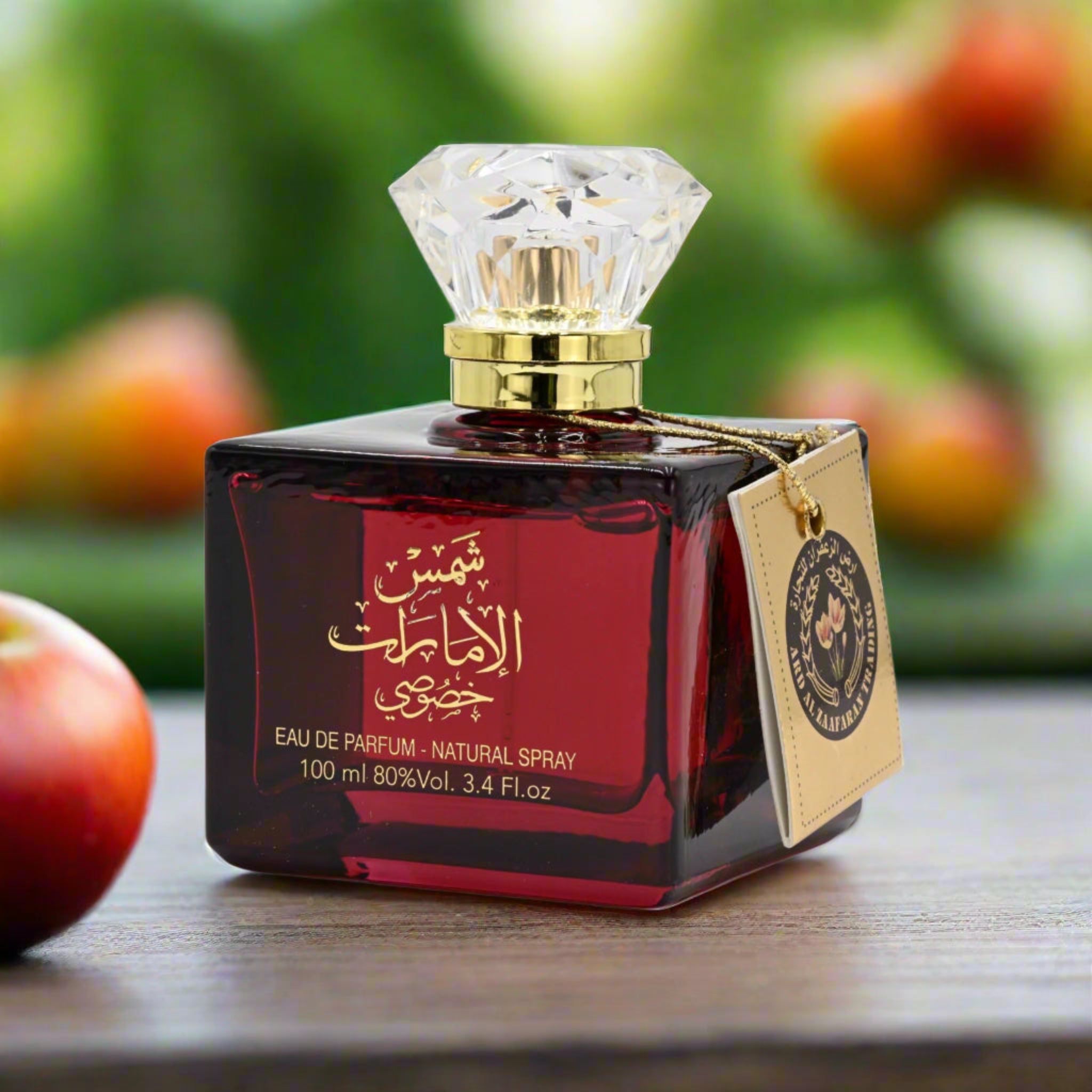 Perfume bottle with a diamond-shaped cap on a wooden surface with apples in the background