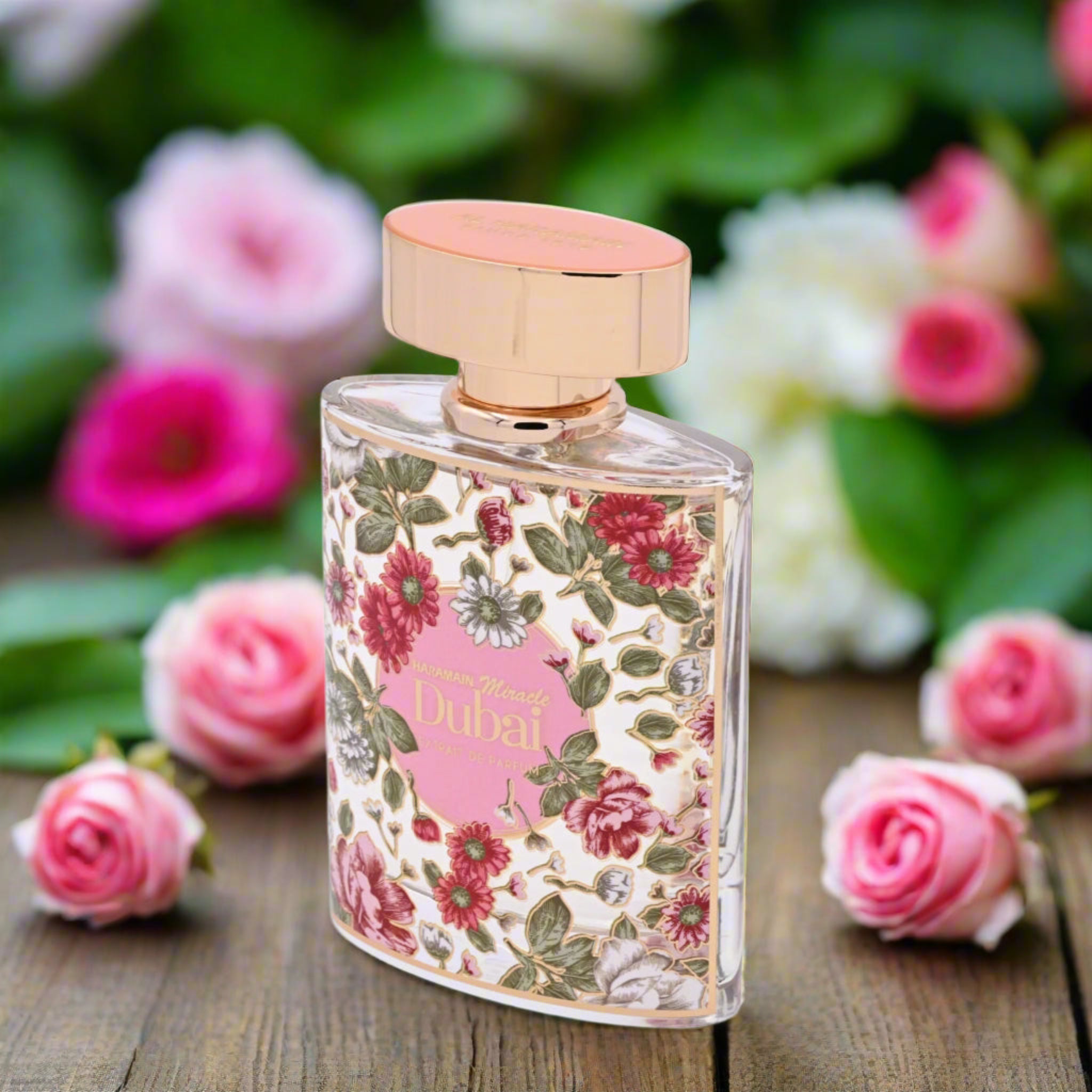 Perfume bottle with floral design on a wooden surface with flowers in the background
