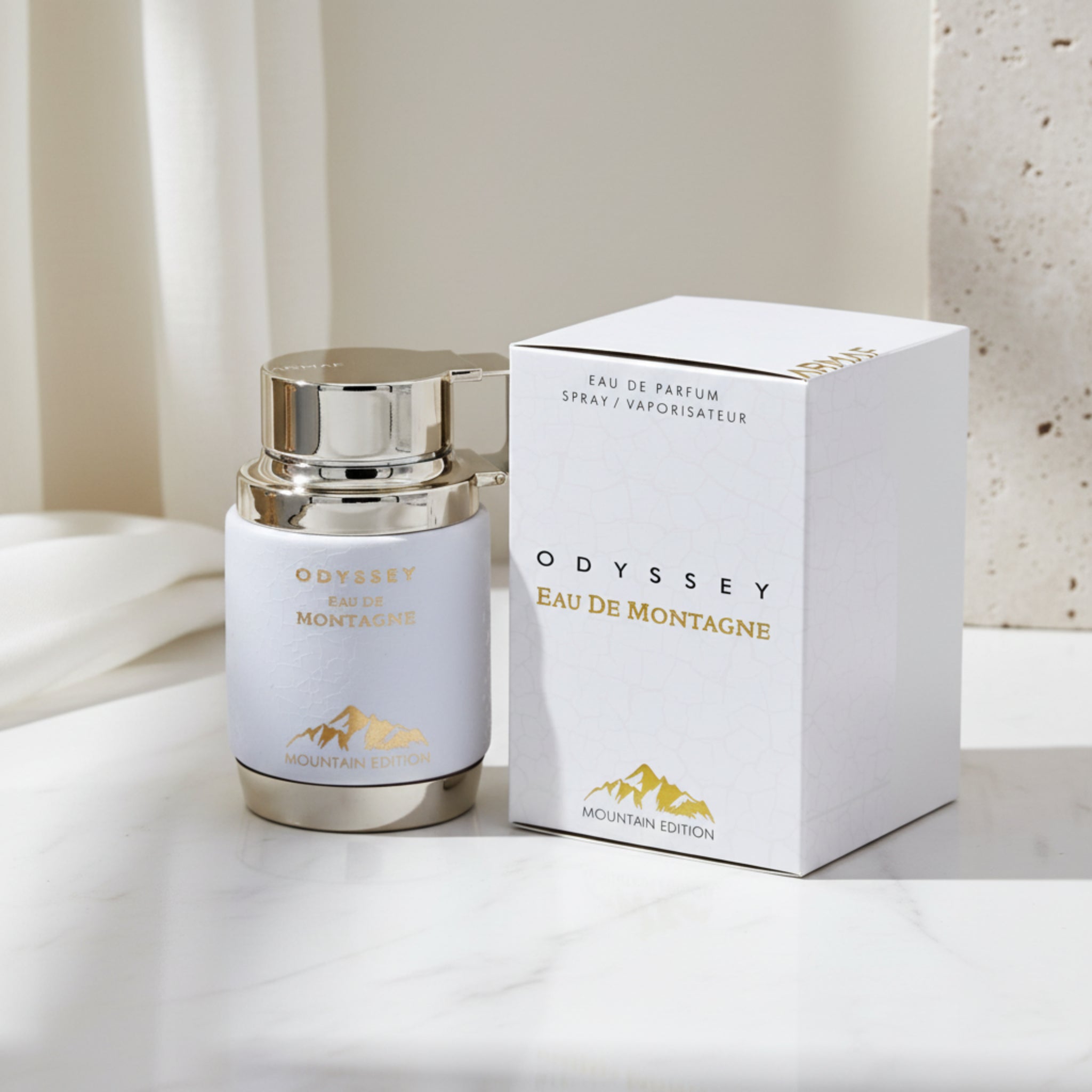 Odyssey Eau de Montagne perfume bottle and packaging on a white background