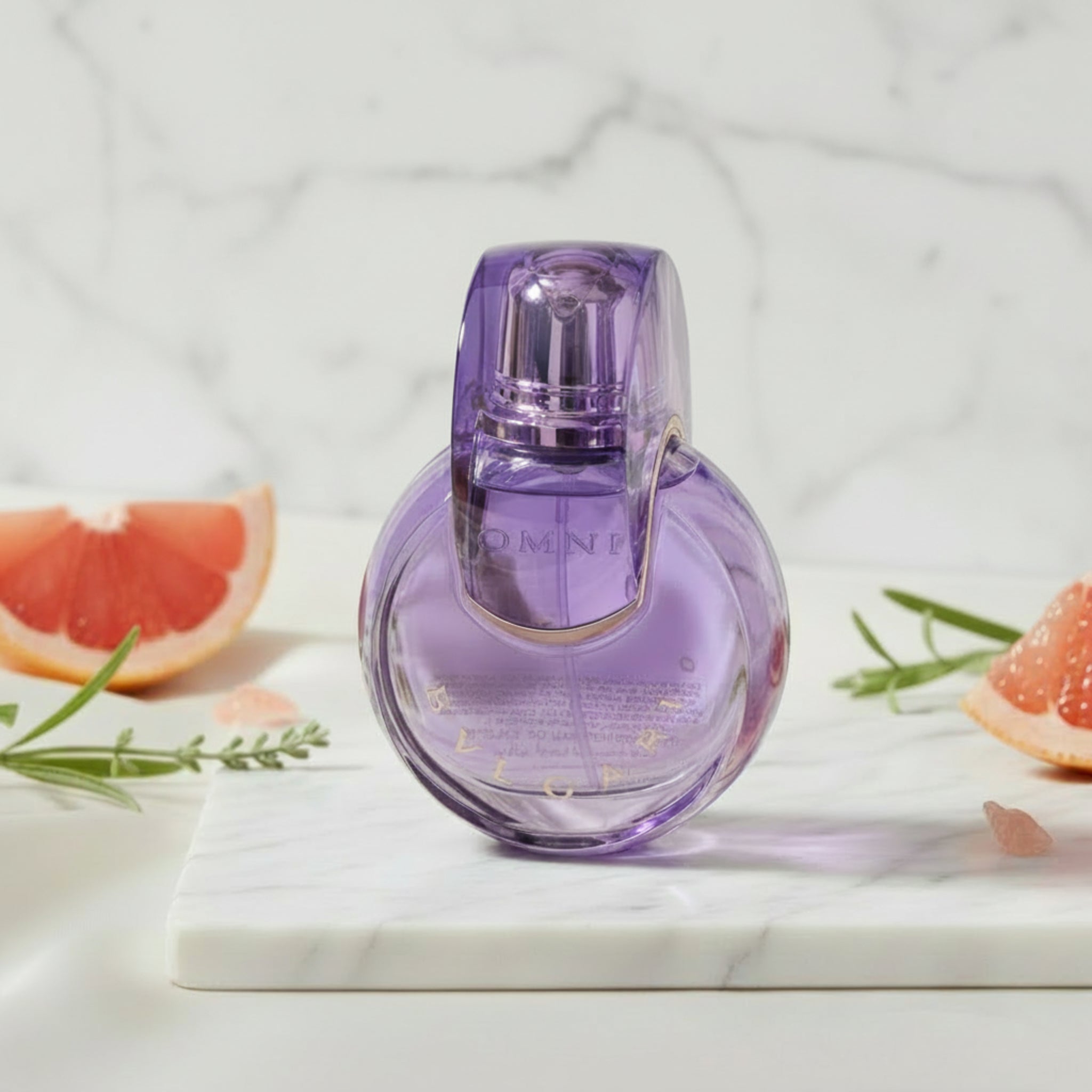 Purple perfume bottle with gold accents on a white background