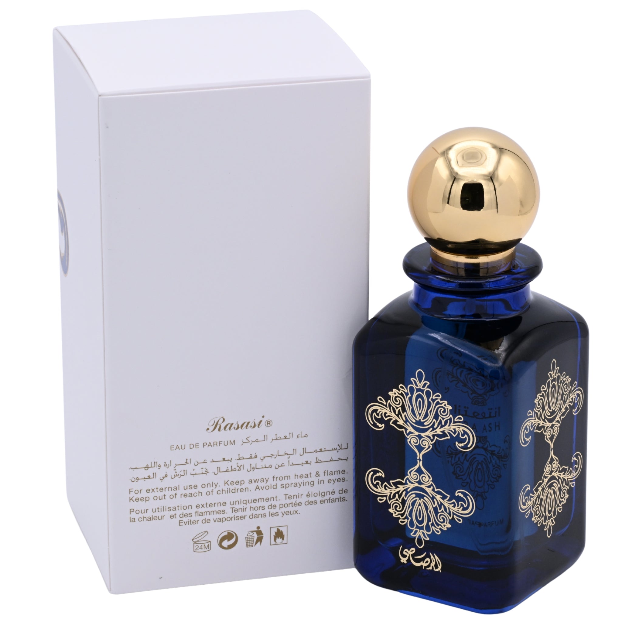 Blue perfume bottle with gold cap and intricate design next to its packaging on a white background