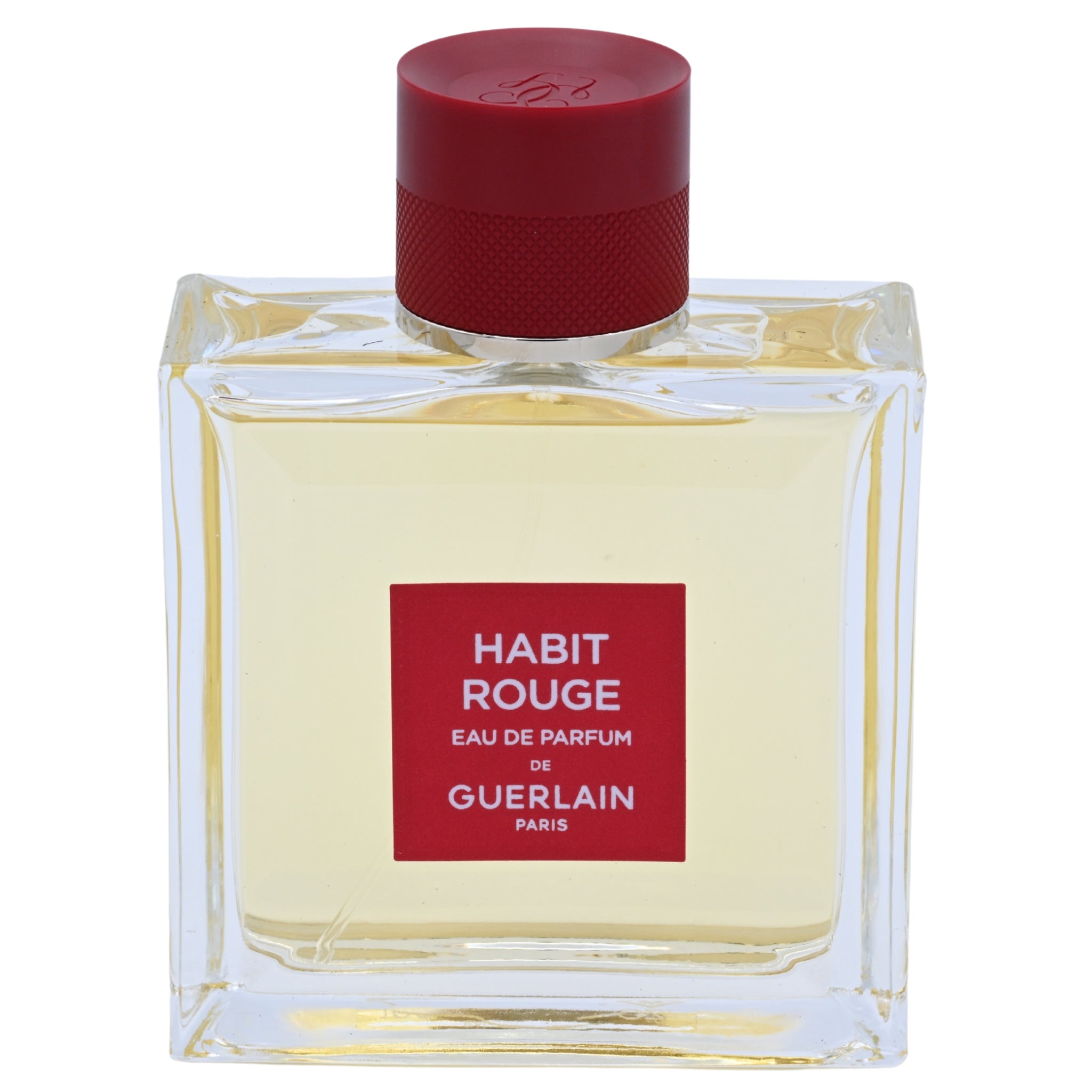 Guerlain Habit Rouge perfume bottle with red cap and label on a white background