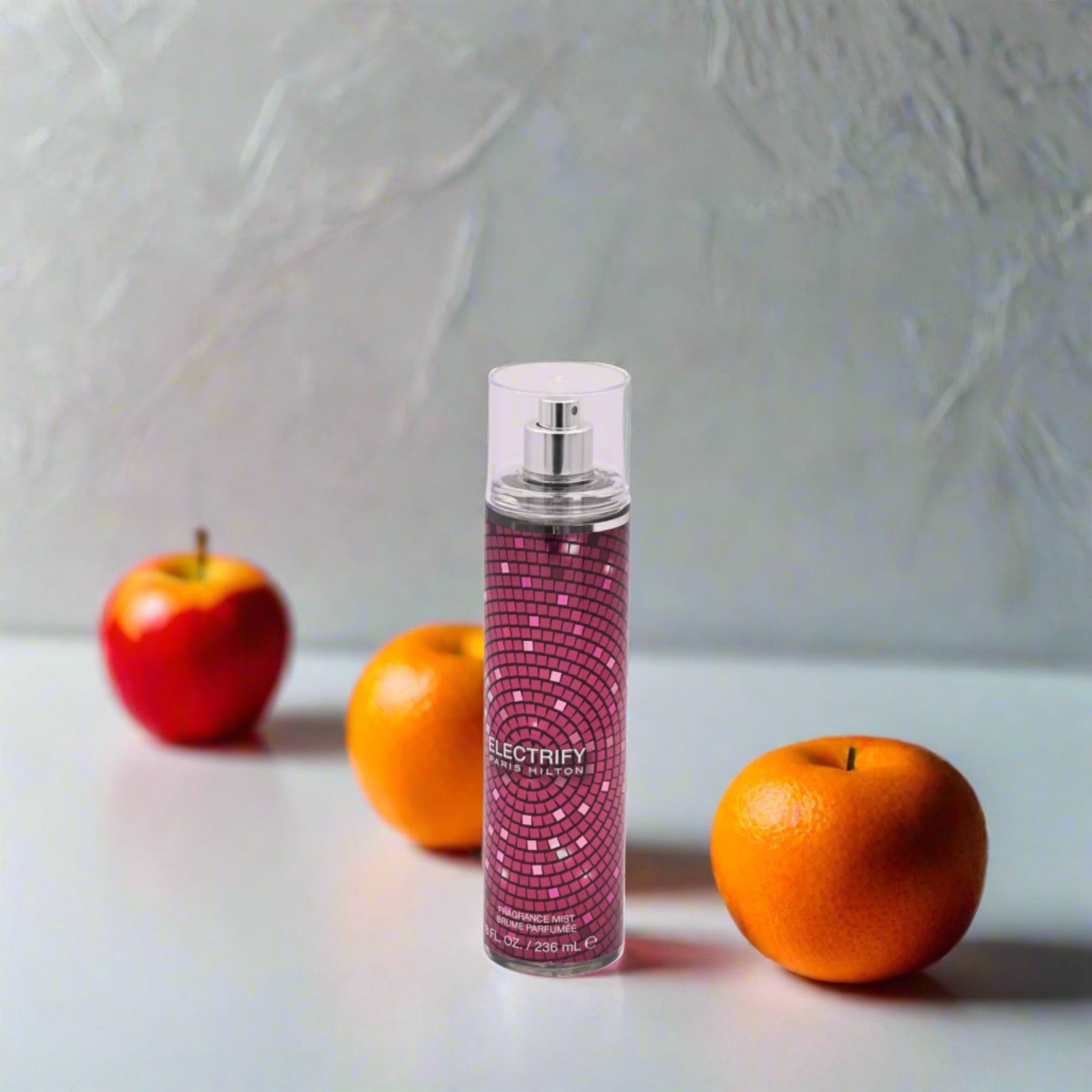 Pink mosaic-patterned spray bottle on a white background
