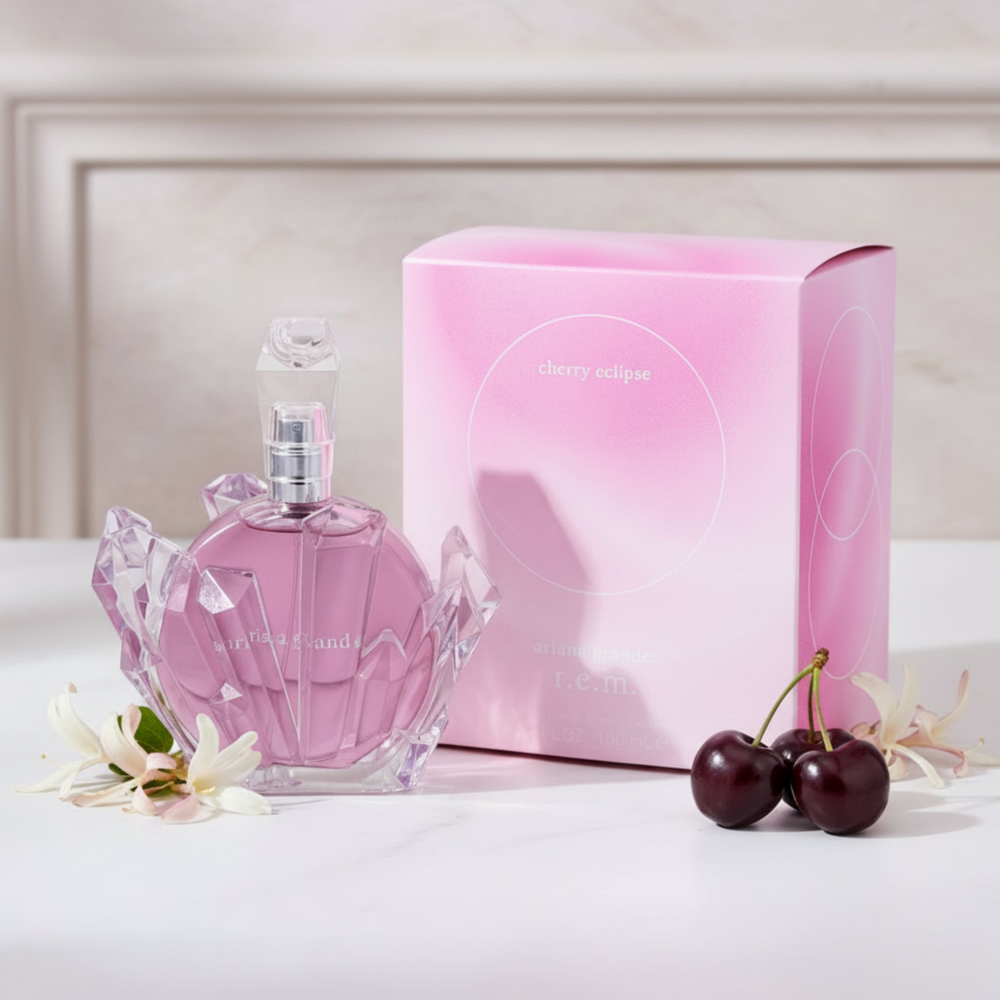 Pink perfume bottle and packaging with 'Cherry Eclipse' text on a white background