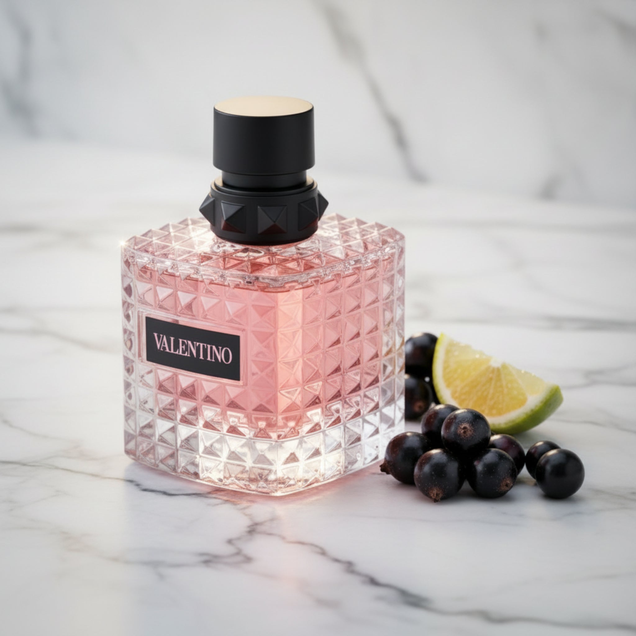 Pink perfume bottle with black cap on a white background