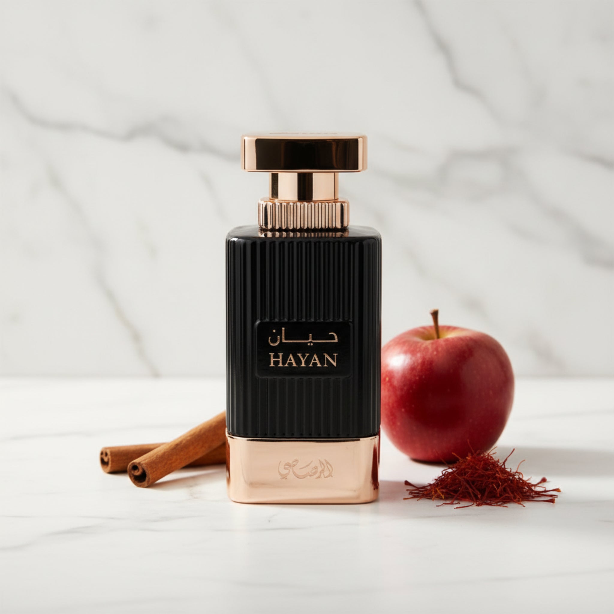 Perfume bottle with black and gold design on a white background