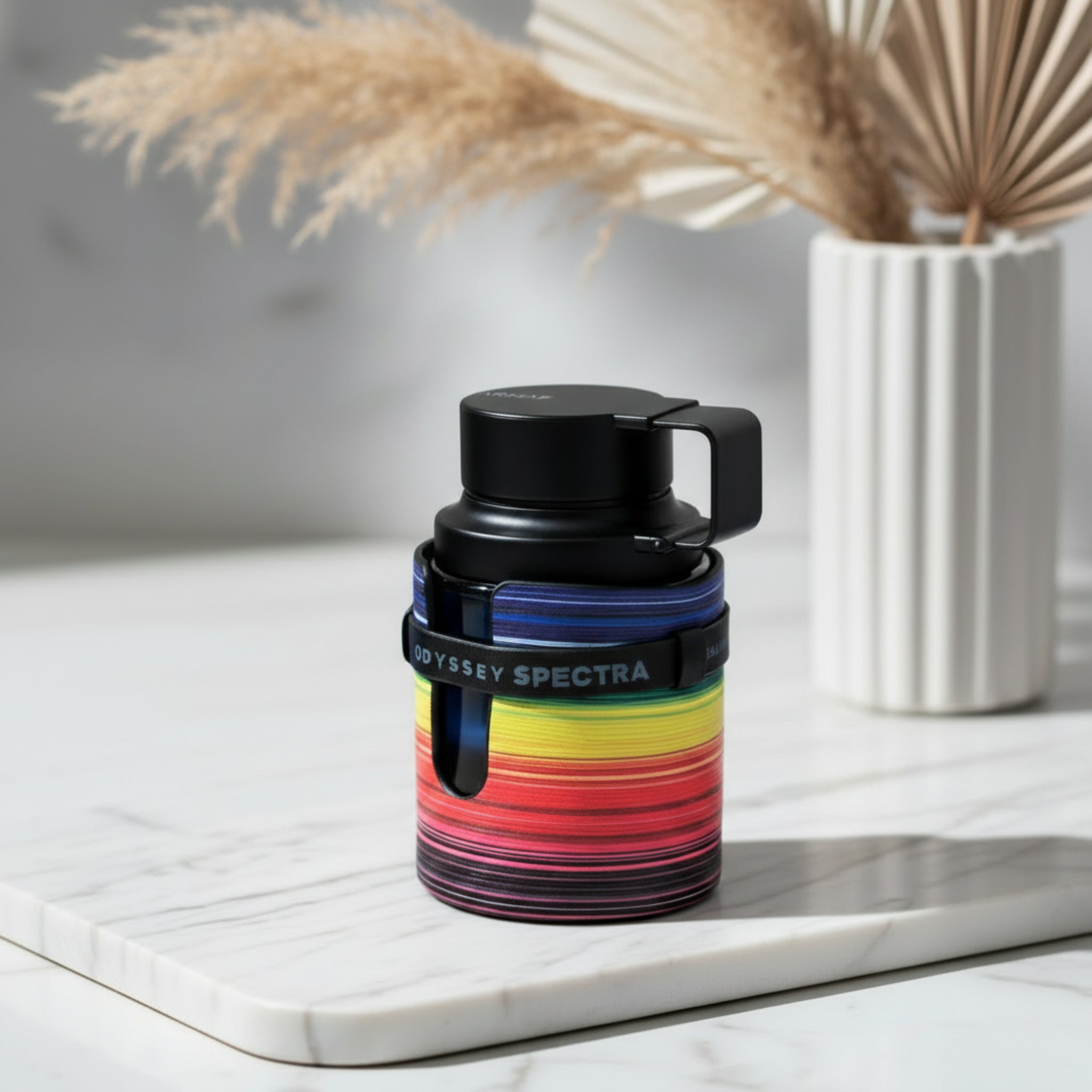 Colorful thermos with black lid on a white background