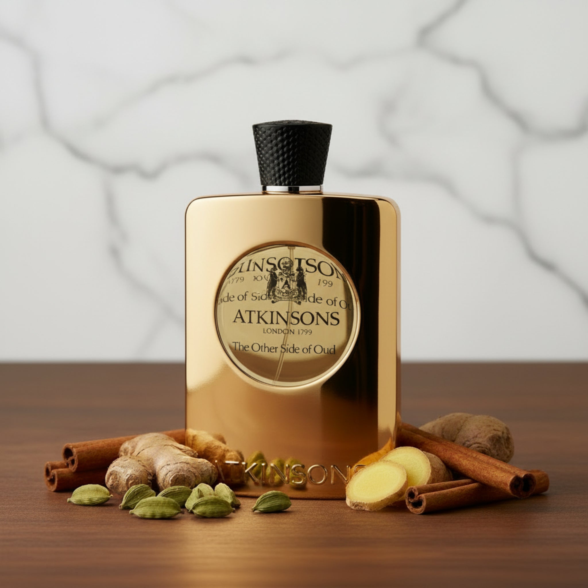 Gold Atkinsons perfume bottle with black cap on a white background