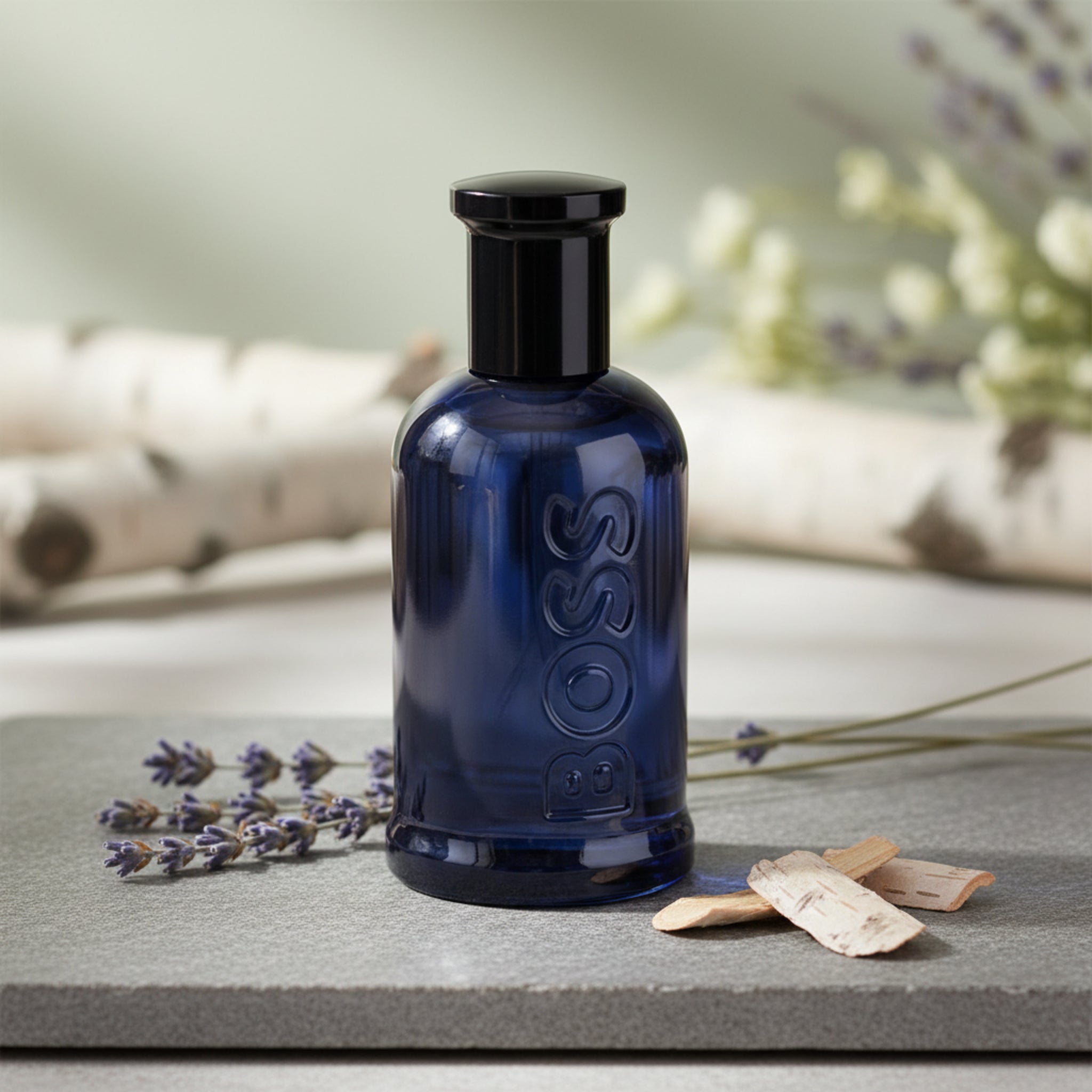 Black perfume bottle with 'BOSS' branding on a white background
