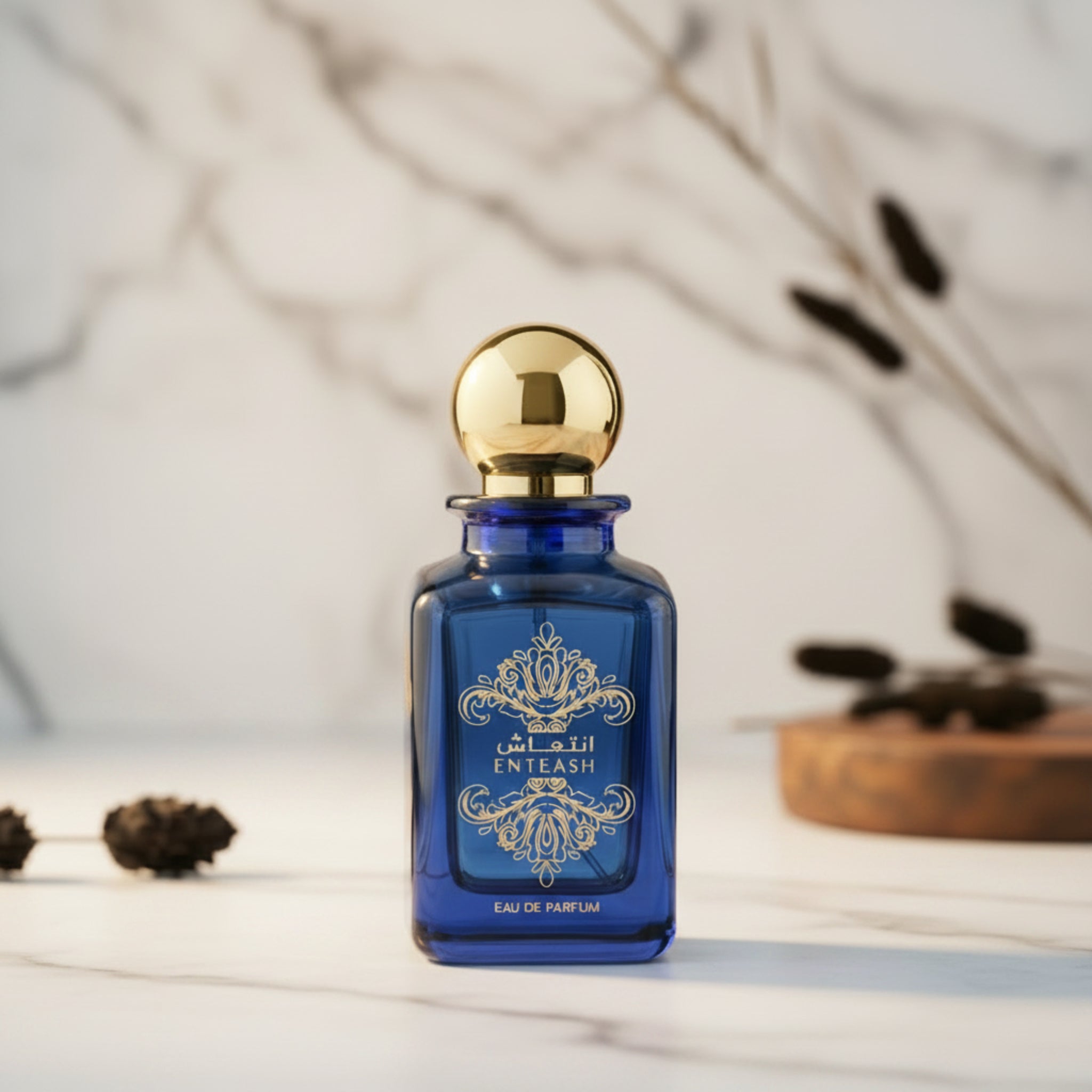 Blue perfume bottle with gold cap on a white background