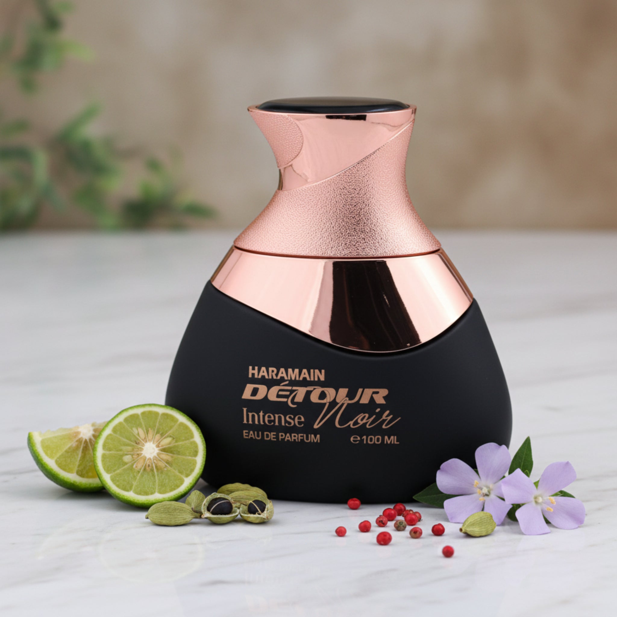 Perfume bottle with rose gold cap and black body on a white background