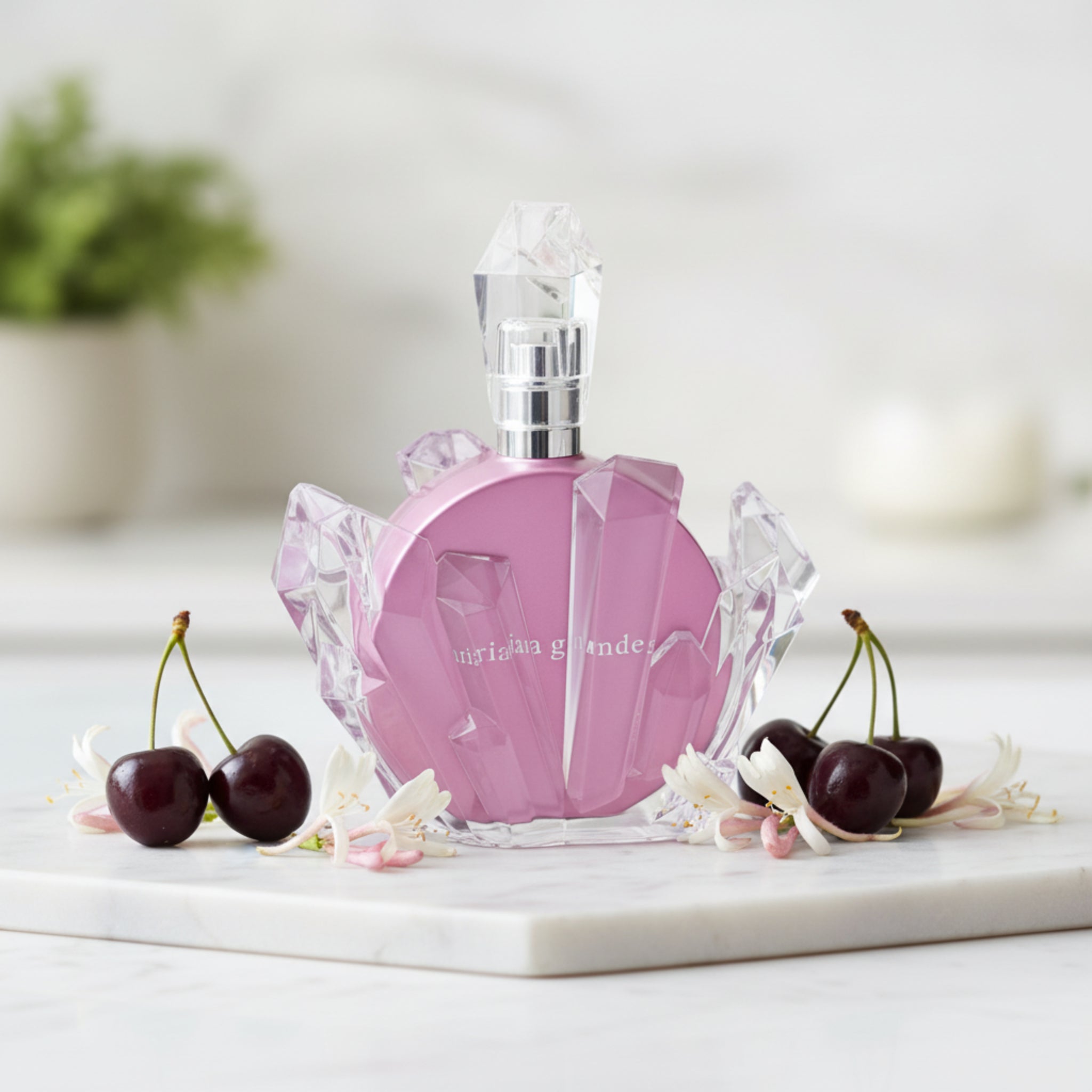 Pink perfume bottle with crystal-like design on a white background