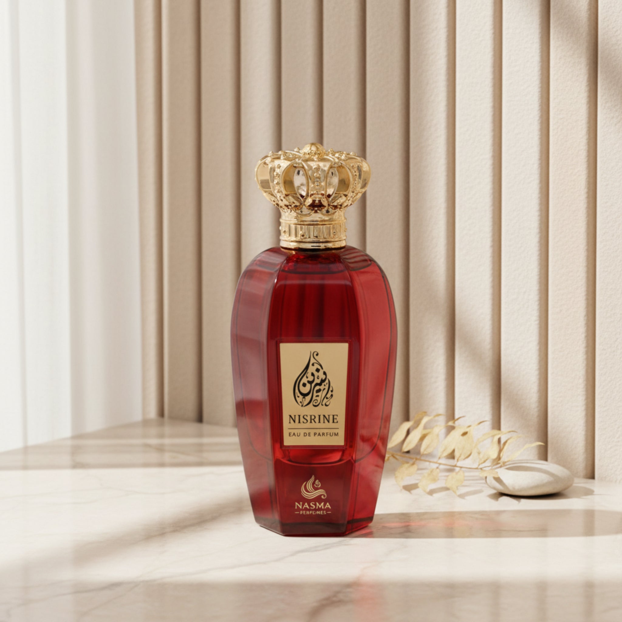 Red perfume bottle with gold cap on a white background