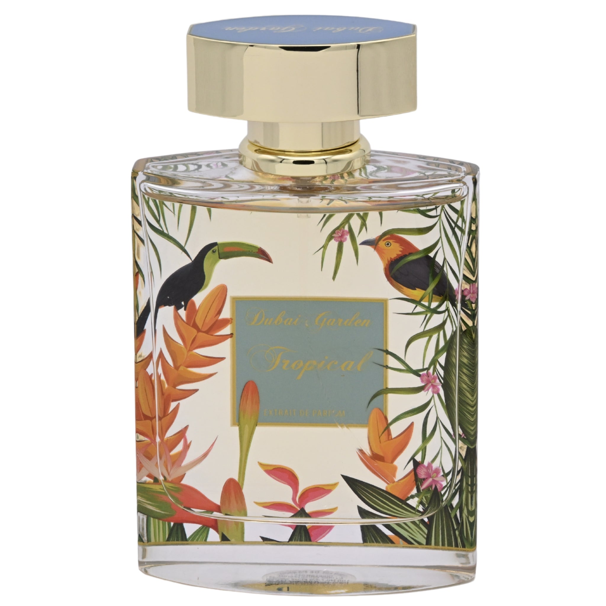 Perfume bottle with tropical design and gold cap on a white background