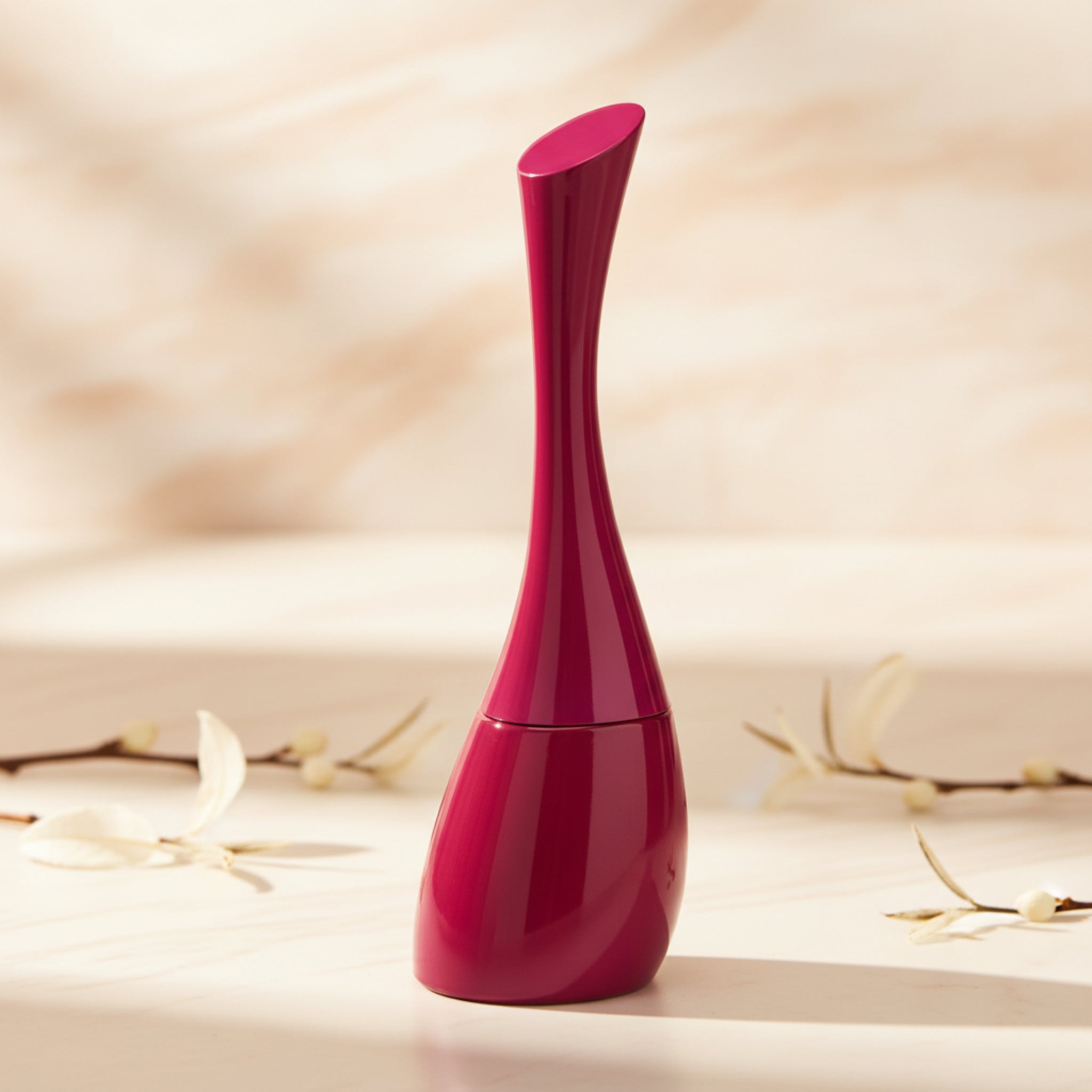 Red and pink perfume bottle on a white background