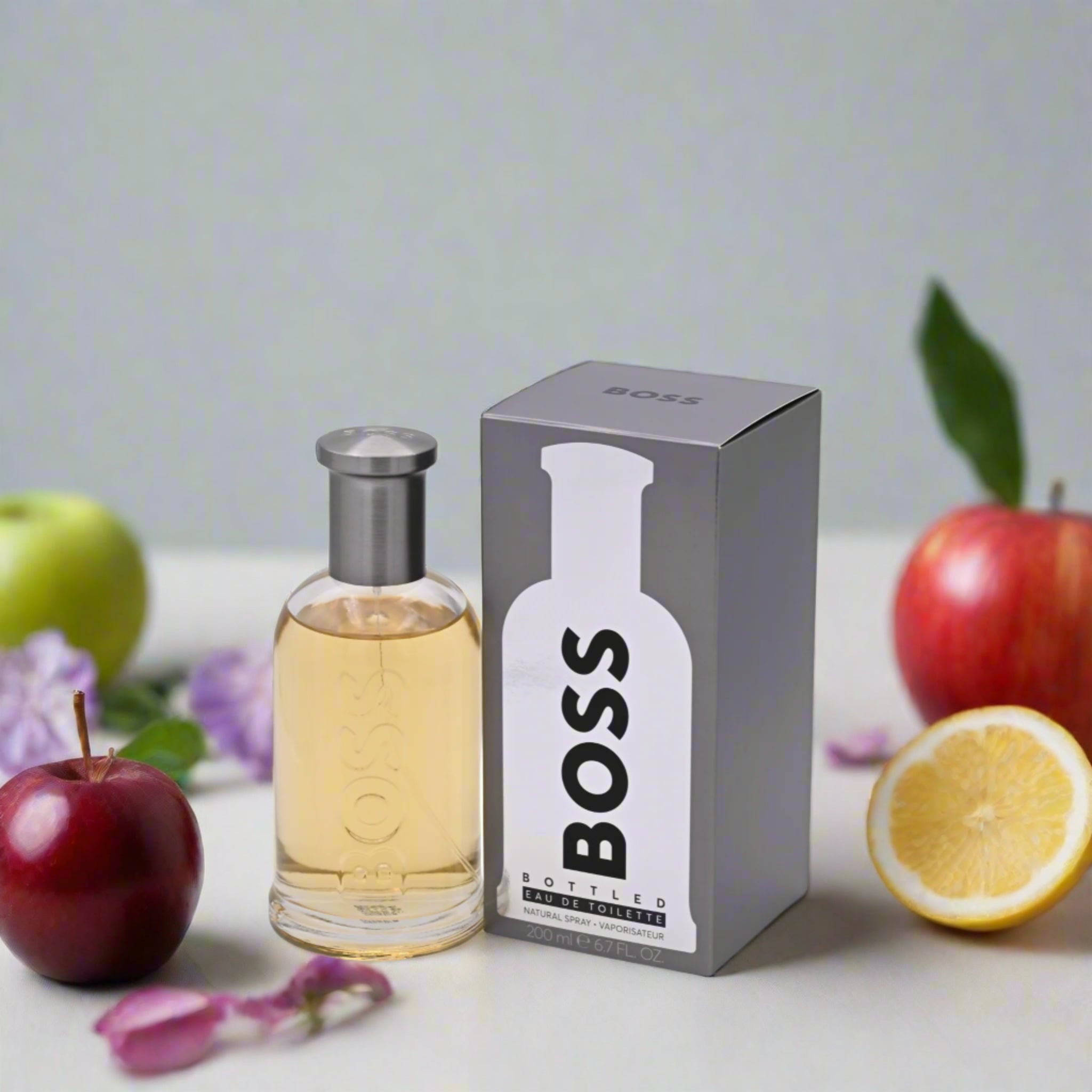 BOSS bottled perfume bottle and packaging on a with fruits