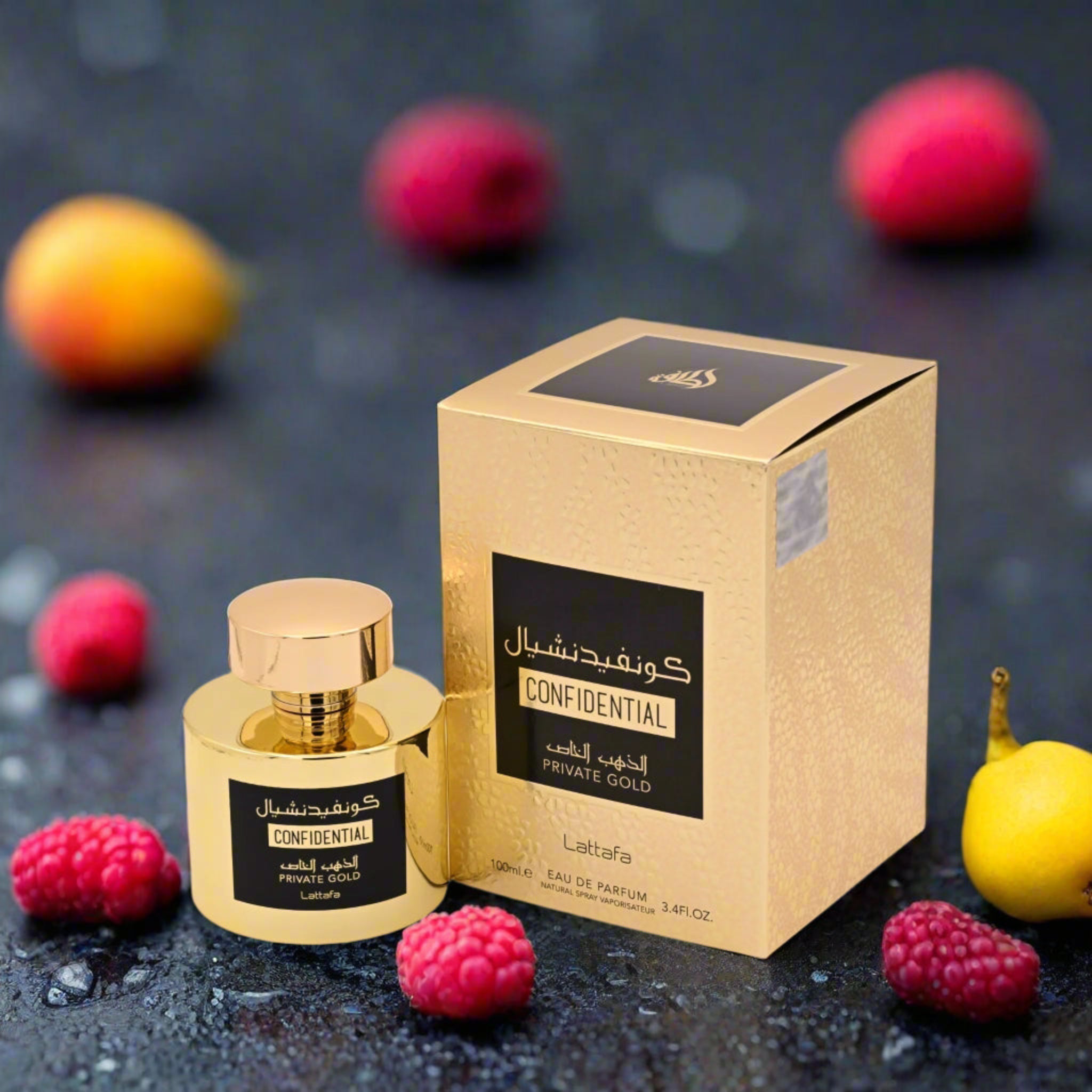Gold perfume bottle and packaging with raspberries and peaches on a dark background