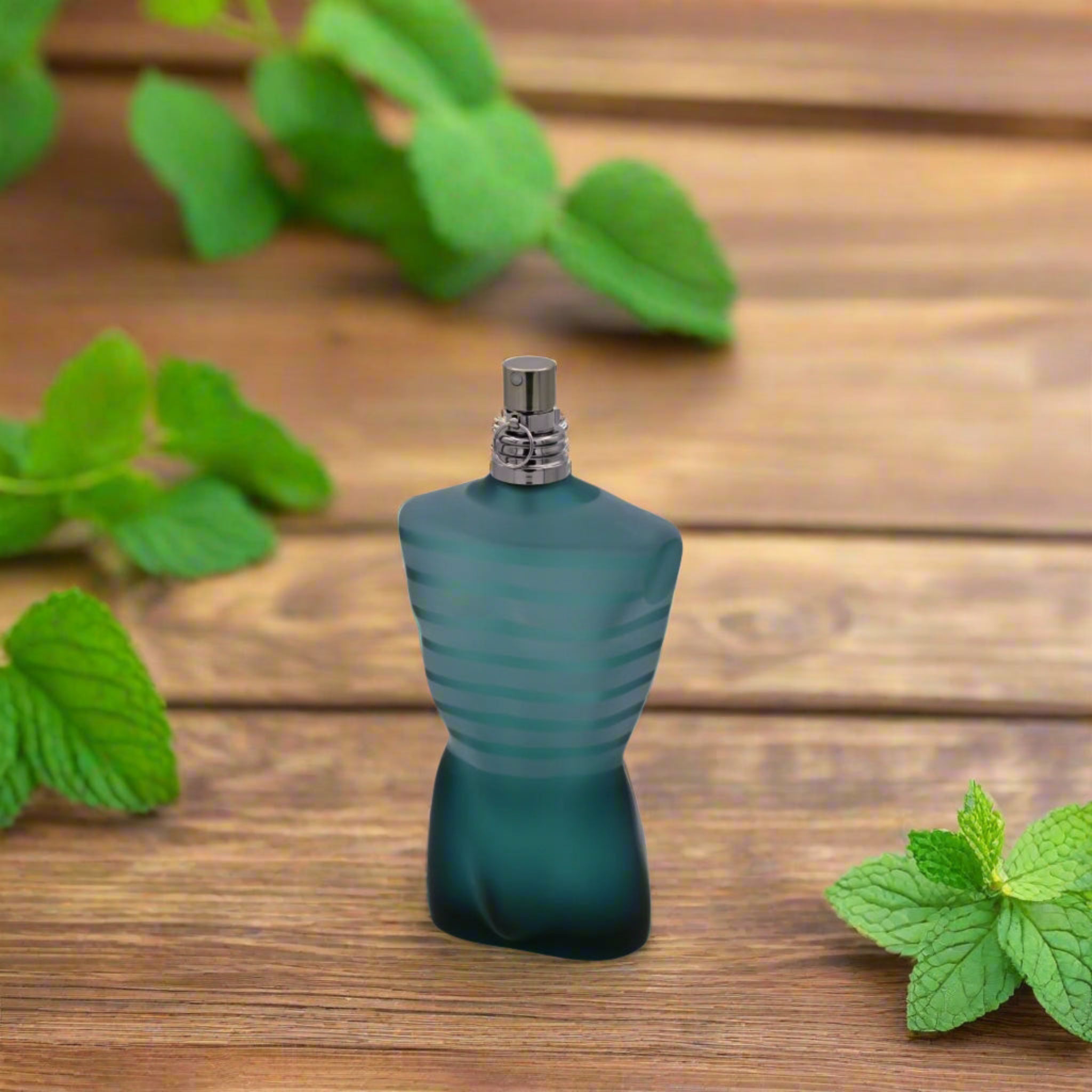 Green perfume bottle on a wooden surface with mint leaves