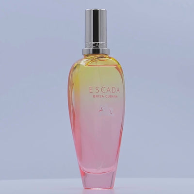 Escada Brisa Cubana perfume bottle rotating on a white podium