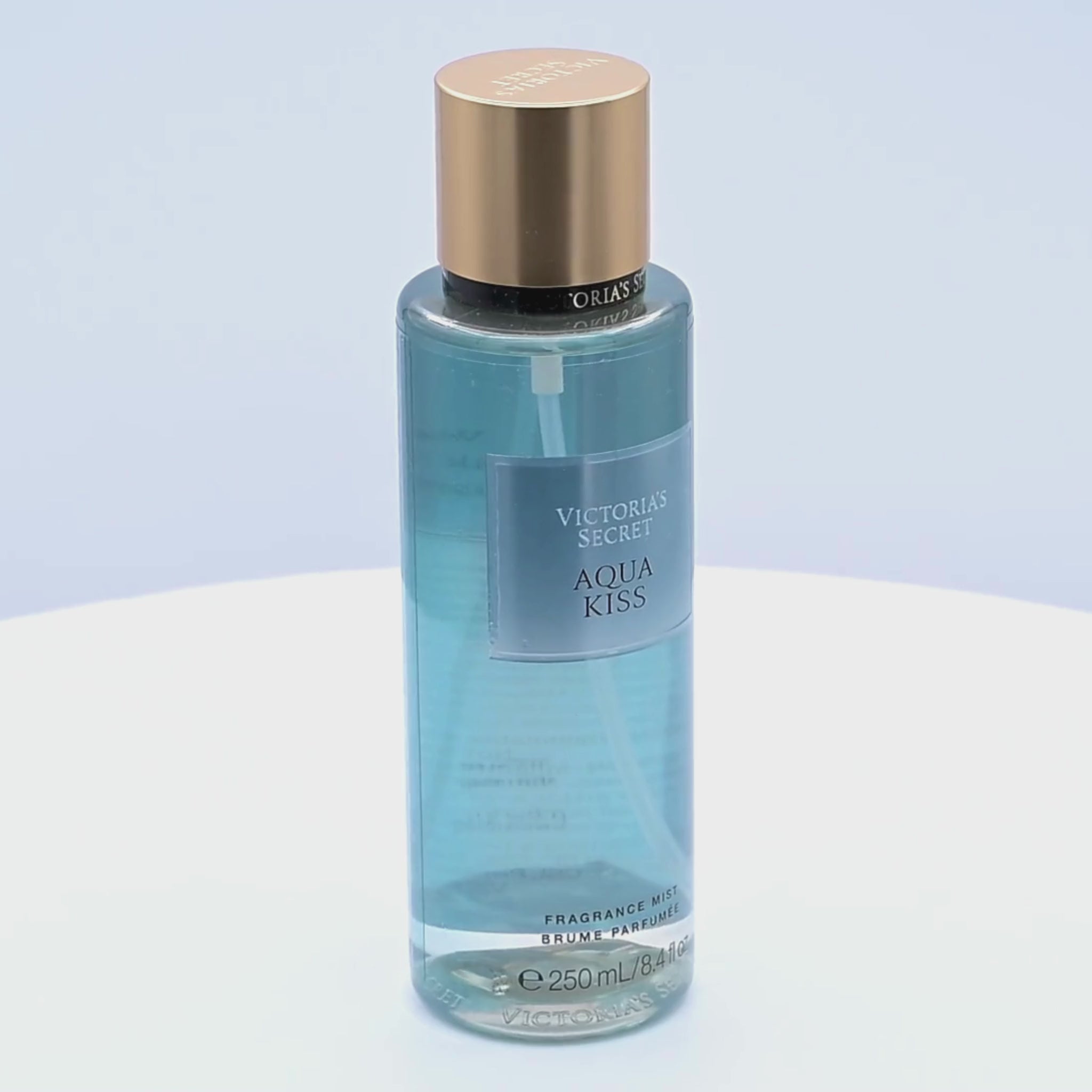 Victoria's Secret Aqua Kiss fragrance mist bottle rotating on a white podium