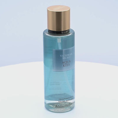 Victoria's Secret Aqua Kiss fragrance mist bottle rotating on a white podium