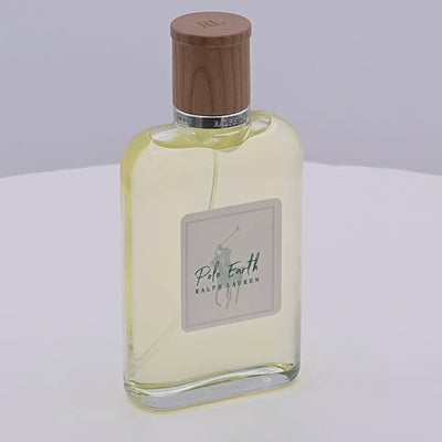 Ralph Lauren Polo Earth perfume bottle with wooden cap rotating on a white podium