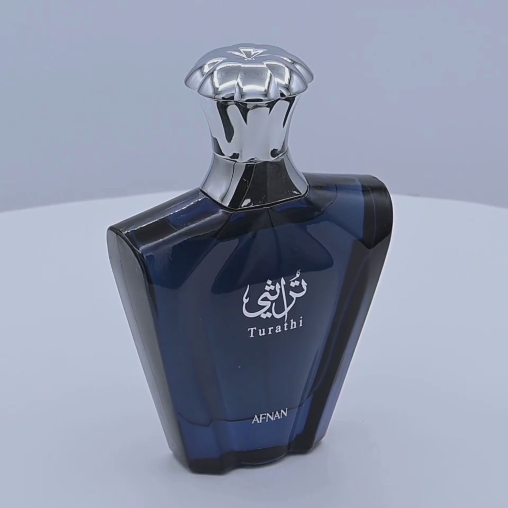 Afnan Turathi Eau de Parfum bottle rotating on a white podium