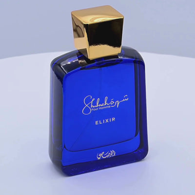 Blue Shubh Om Elixir perfume bottle rotating on a white podium