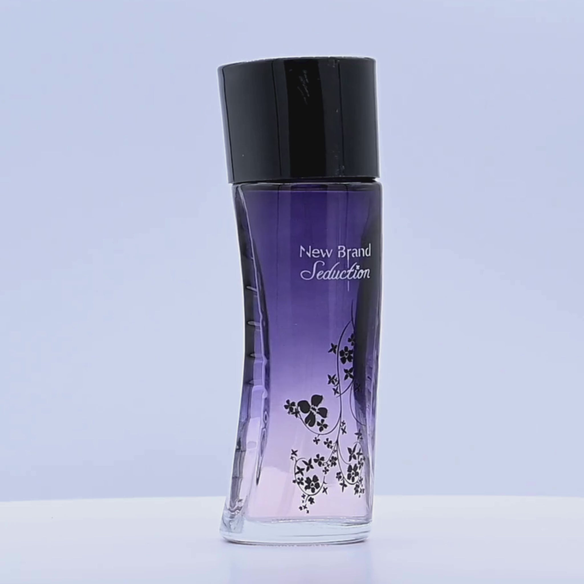 Perfume bottle labeled 'New Brand Seduction' rotating on a white podium