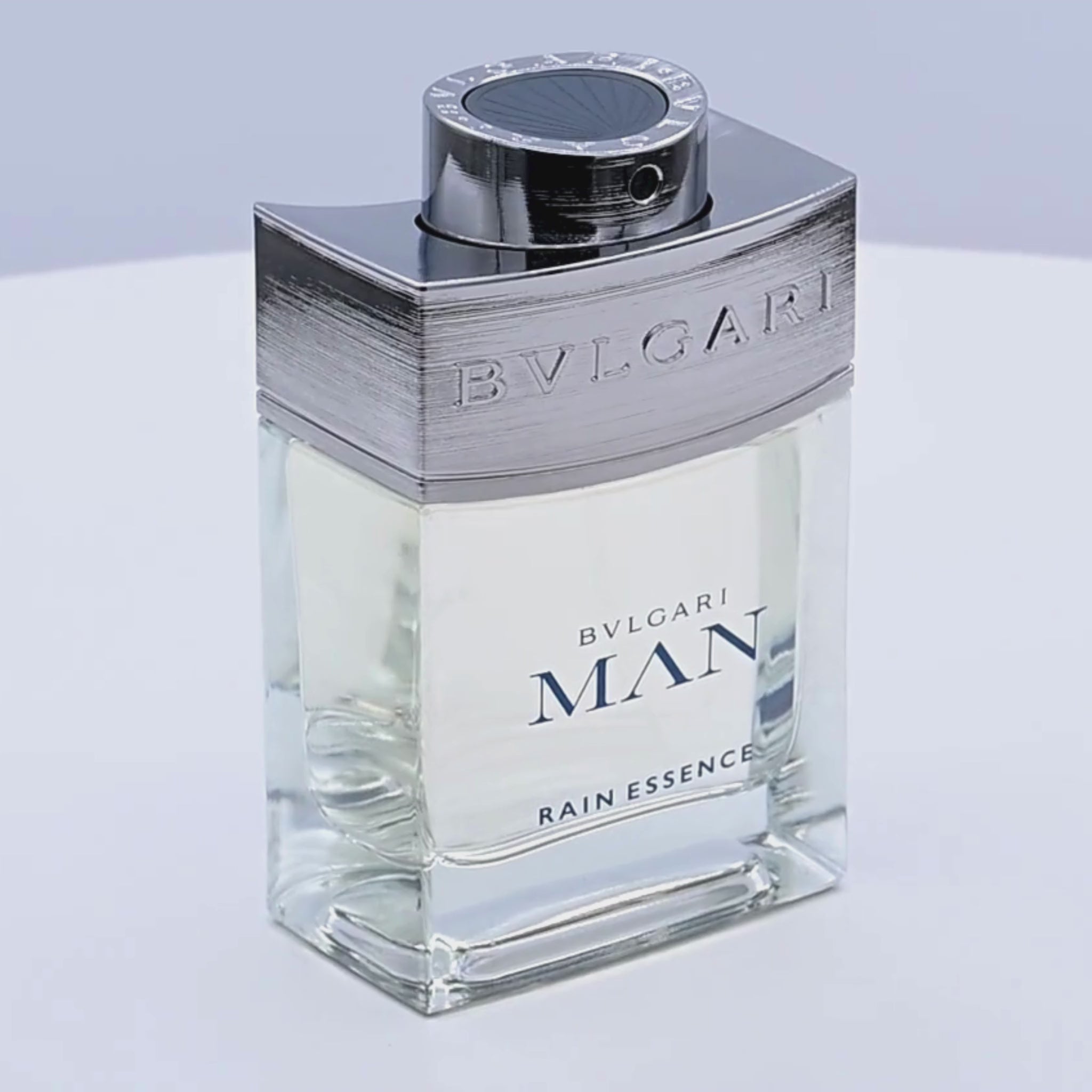 Bvlgari Man Rain Essence eau de parfum bottle rotatig on a white podium