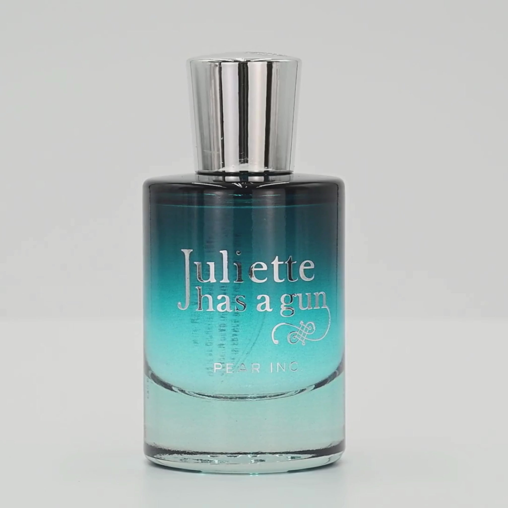 Juliette has a gun Pear Inc. perfume bottle rotating on a white podium