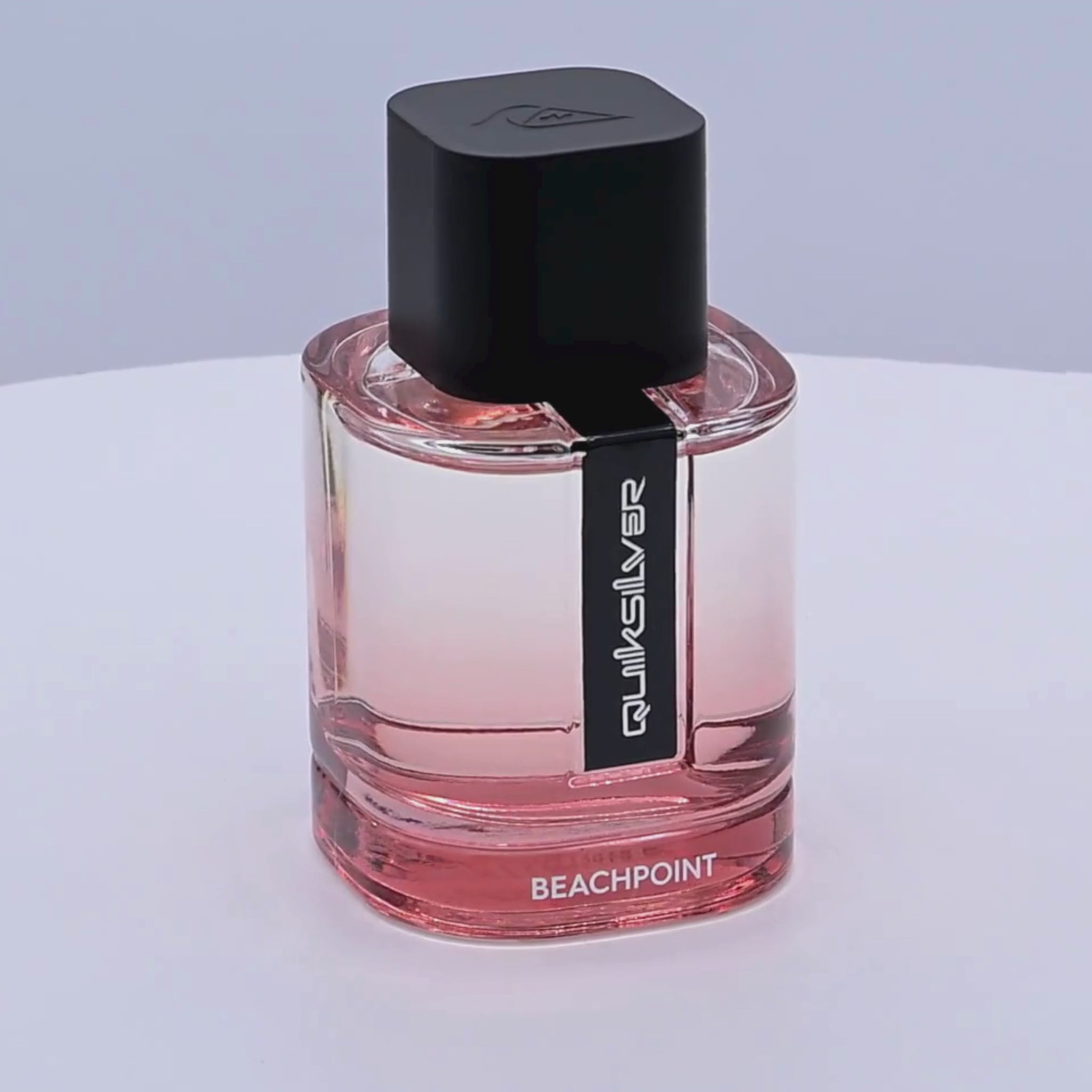 Quiksilver Beachpoint perfume bottle rotating on a white podium