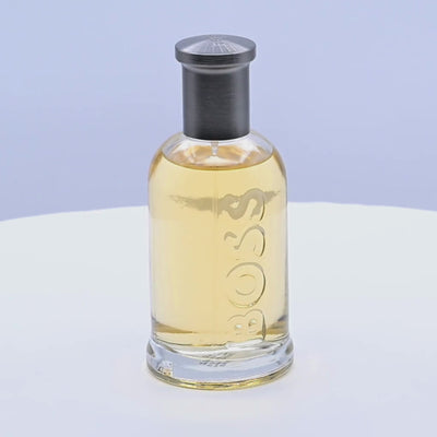 BOSS bottled eau de toilette rotating on a white podium