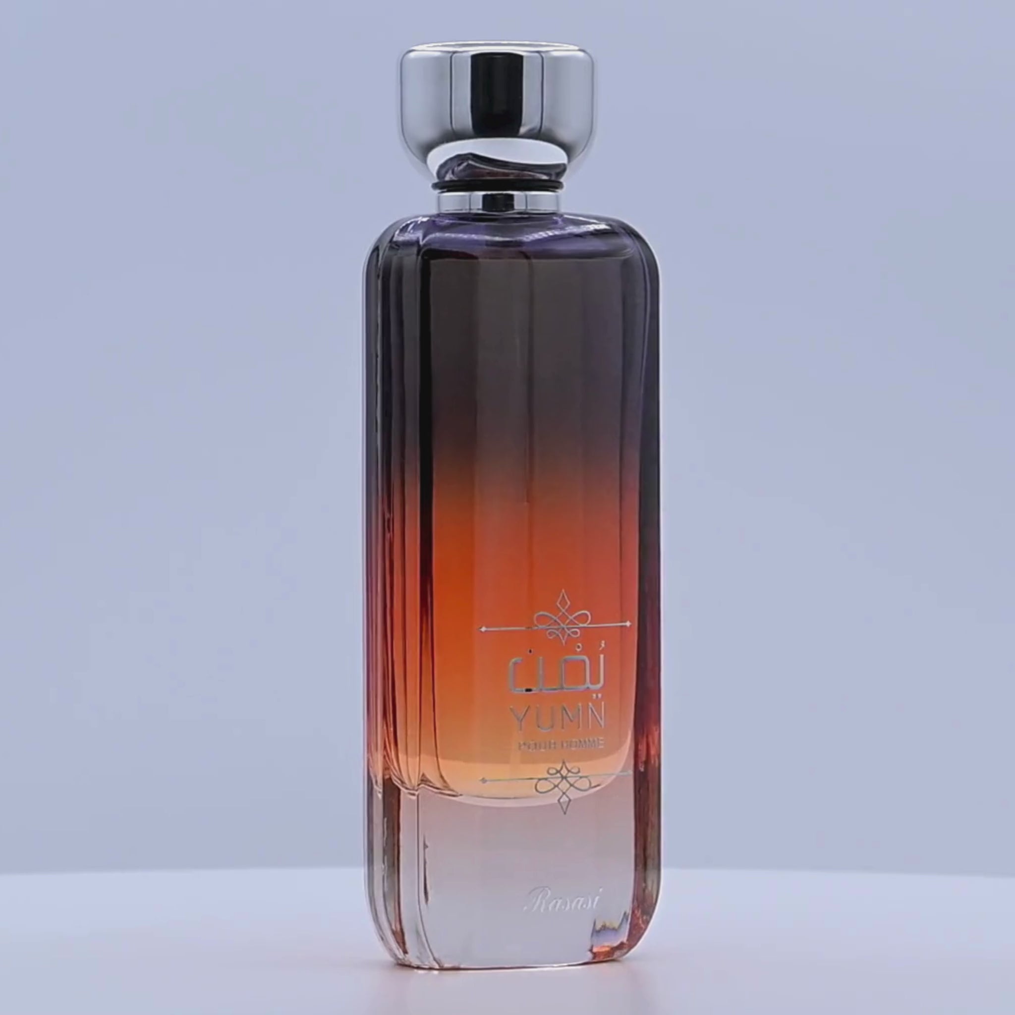 Perfume bottle rotating on a white podium