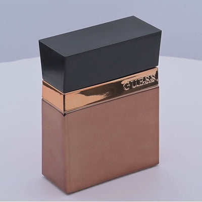 Guess Seductive Homme Desire perfume bottle rotating on a white podium
