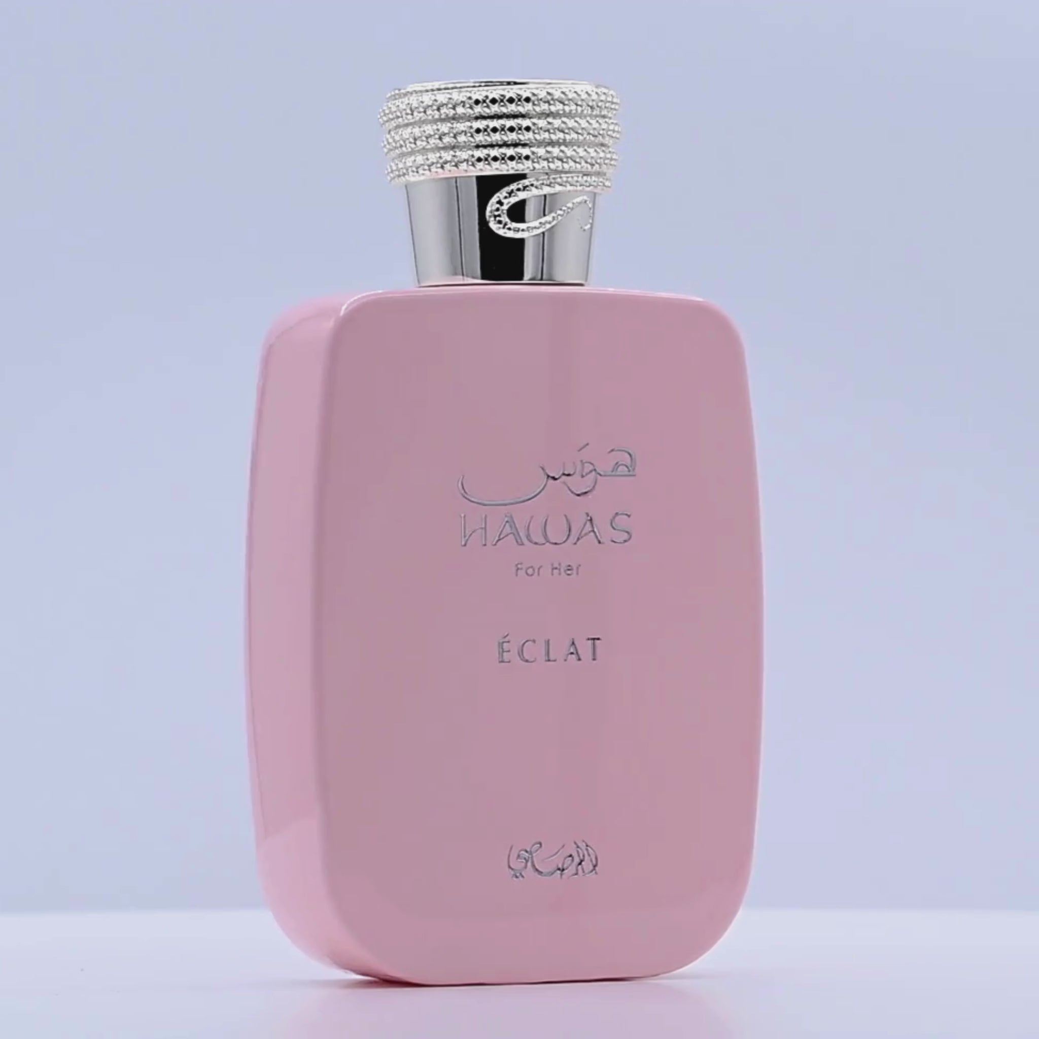 Pink HAWAS Eclat perfume bottle rotating on a white podium